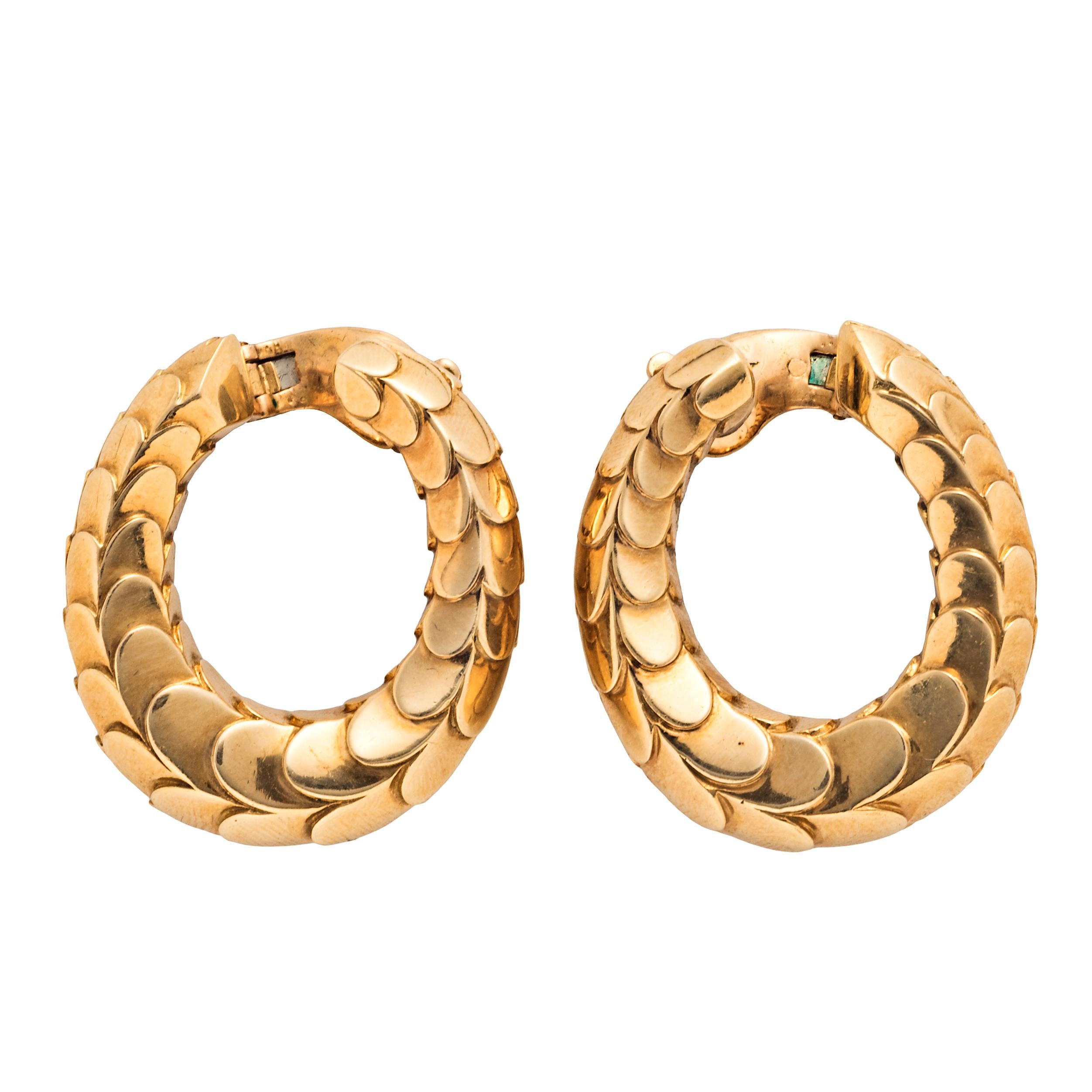 The height of mid-century chic from Cartier Paris, these elegant gold hoop earrings were designed by George Lenfant in 1965. They have a smooth scale pattern and are fitted with clip backs for both pierced and non-pierced ears.  

1-1/2” long x