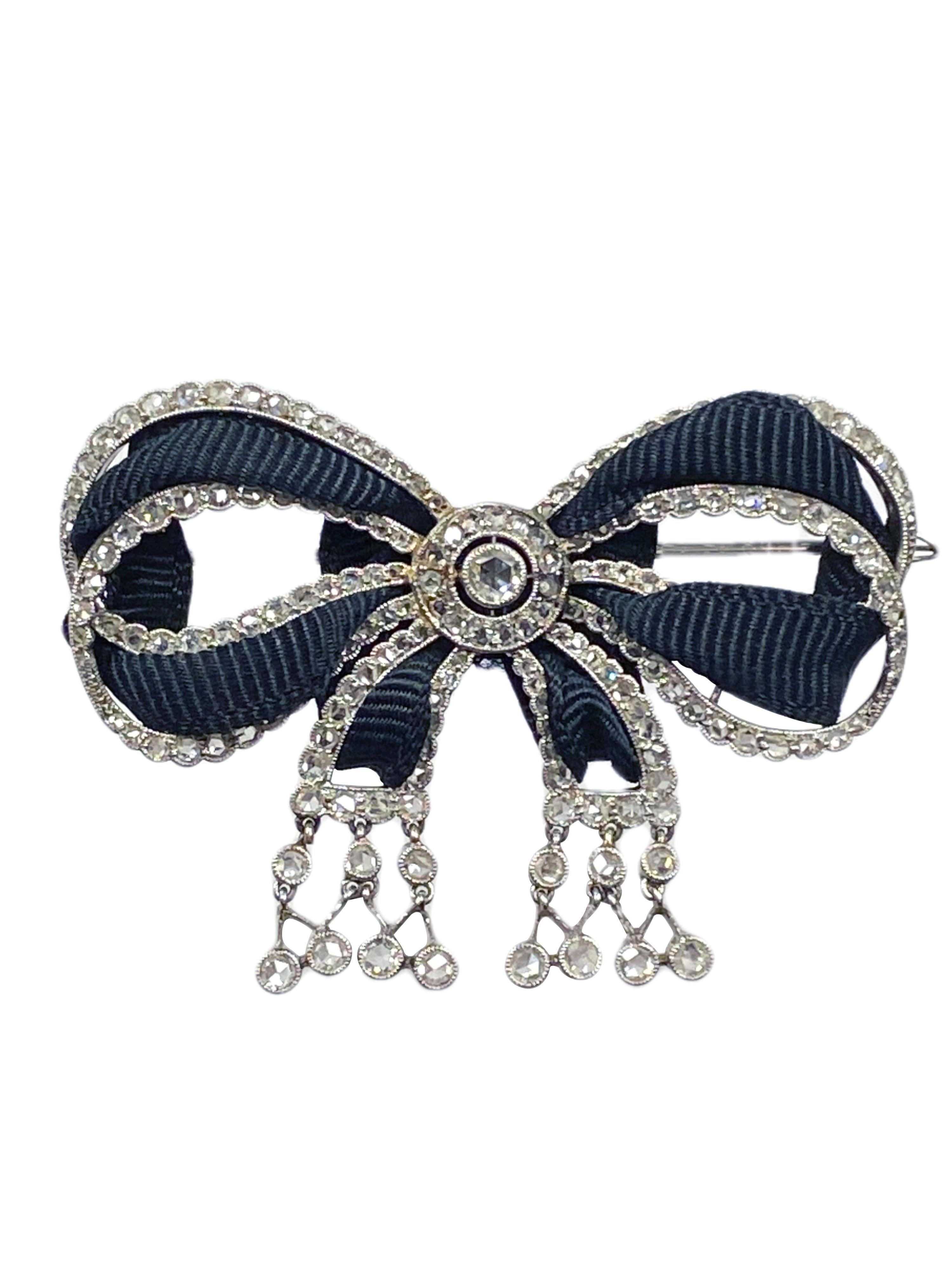 Circa 1910 Cartier Paris Platinum Bow Brooch in the Edwardian Belle Epoque style, measuring 2 1/4 inches in length X 1 1/2 inches. Fine Milgrain work and set throughout with Rose cut Diamonds totaling approximately 3 Carats. Further enhanced with