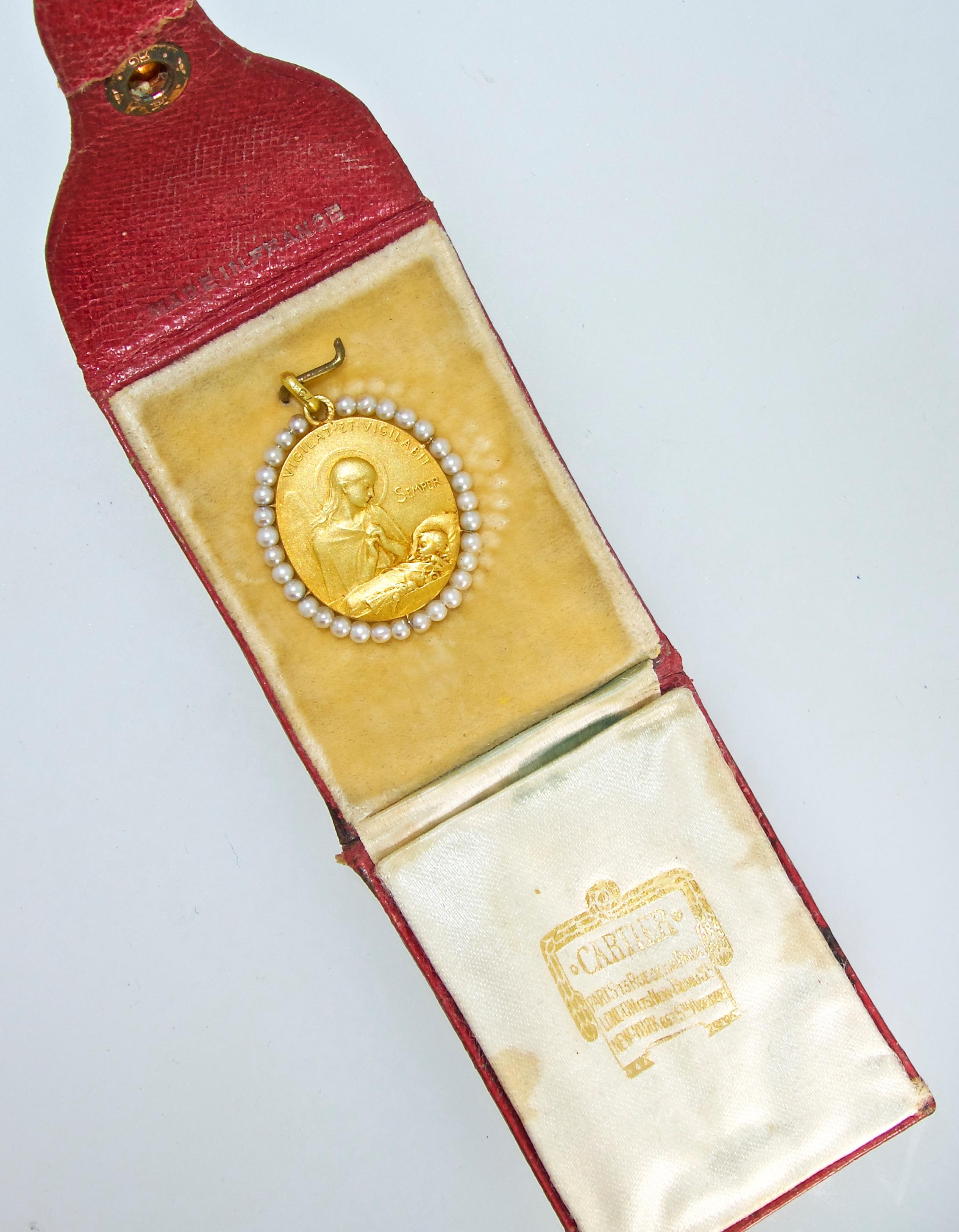 Cartier's Madonna and child pendant in the original fitted box.  This exquisite piece with natural pearls and decorated on both sides is a tour de force of fine French workmanship by a true master of jewelry making.  