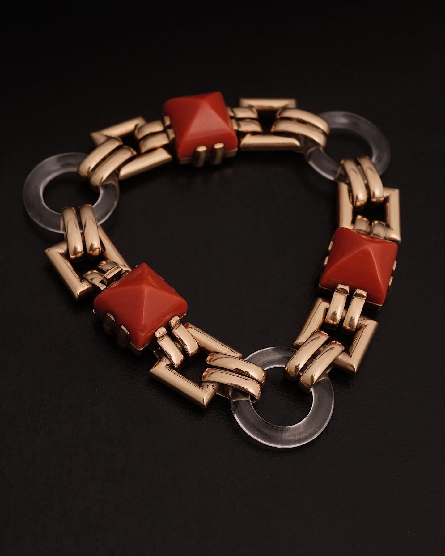 Cartier, Paris
Stunning 18k Gold, Coral and Rock Cristal, Circa 1926
Three coral stones and three round pieces of rock crystal, linked by gold chains. 
Signed Cartier and numbered.
Length 19 cm, gross weight 40 grams.

Very Rare drawing by the