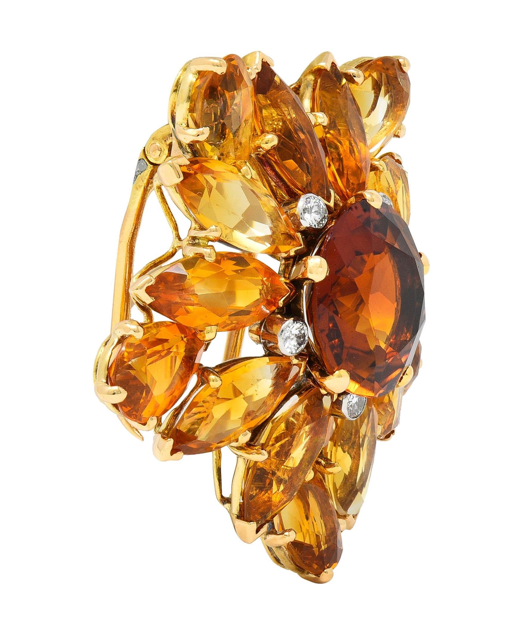 Centering a round cut citrine weighing approximately 5.81 carats - transparent dark brownish orange 
Prong set with a halo surround of round brilliant cut diamonds set in platinum-topped bezels
Weighing approximately 0.30 carat total - eye clean and