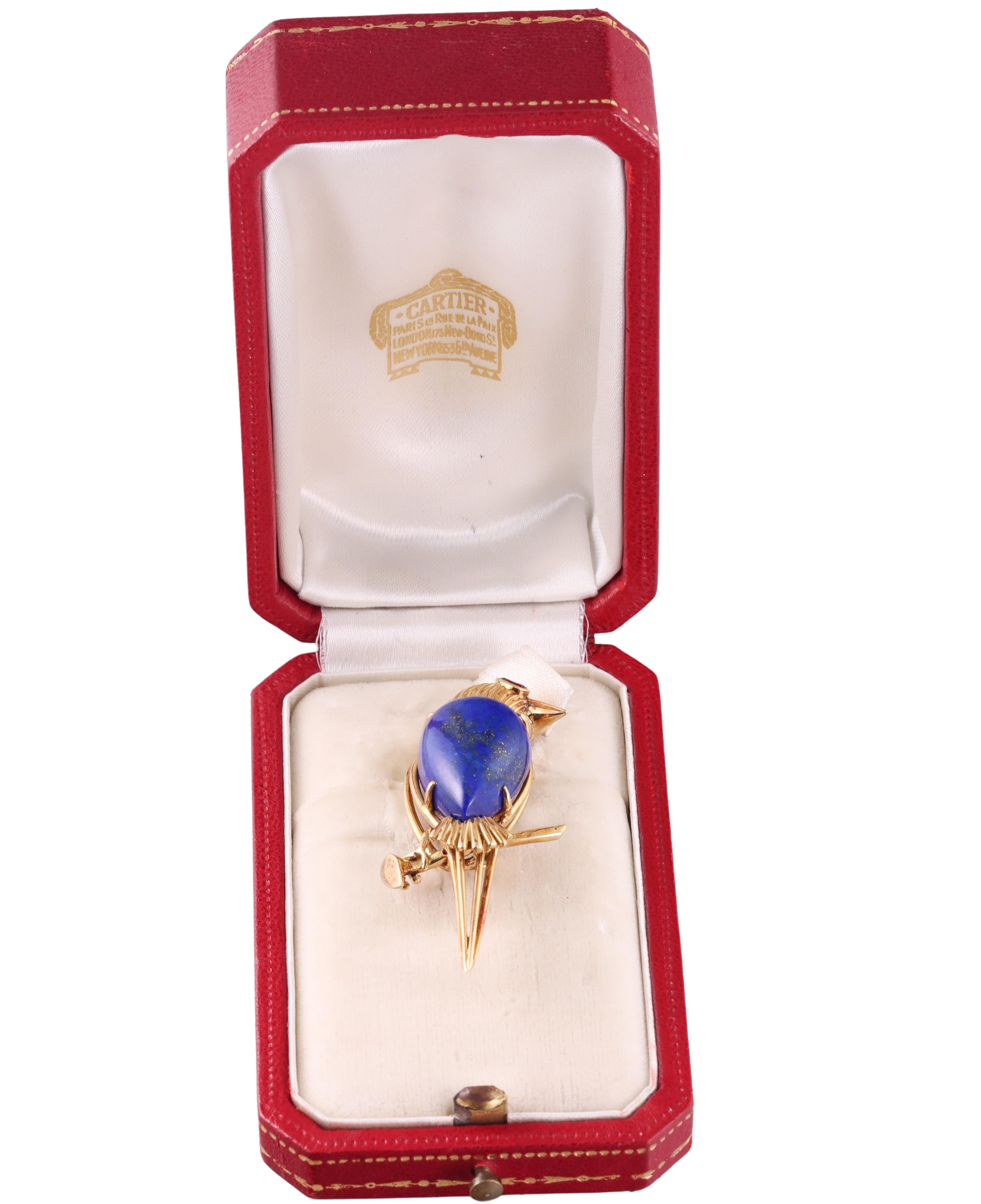Vintage, circa 1960s 18k gold bird brooch by Cartier, set with lapis lazuli and a ruby eye. The brooch measures 1 7/8