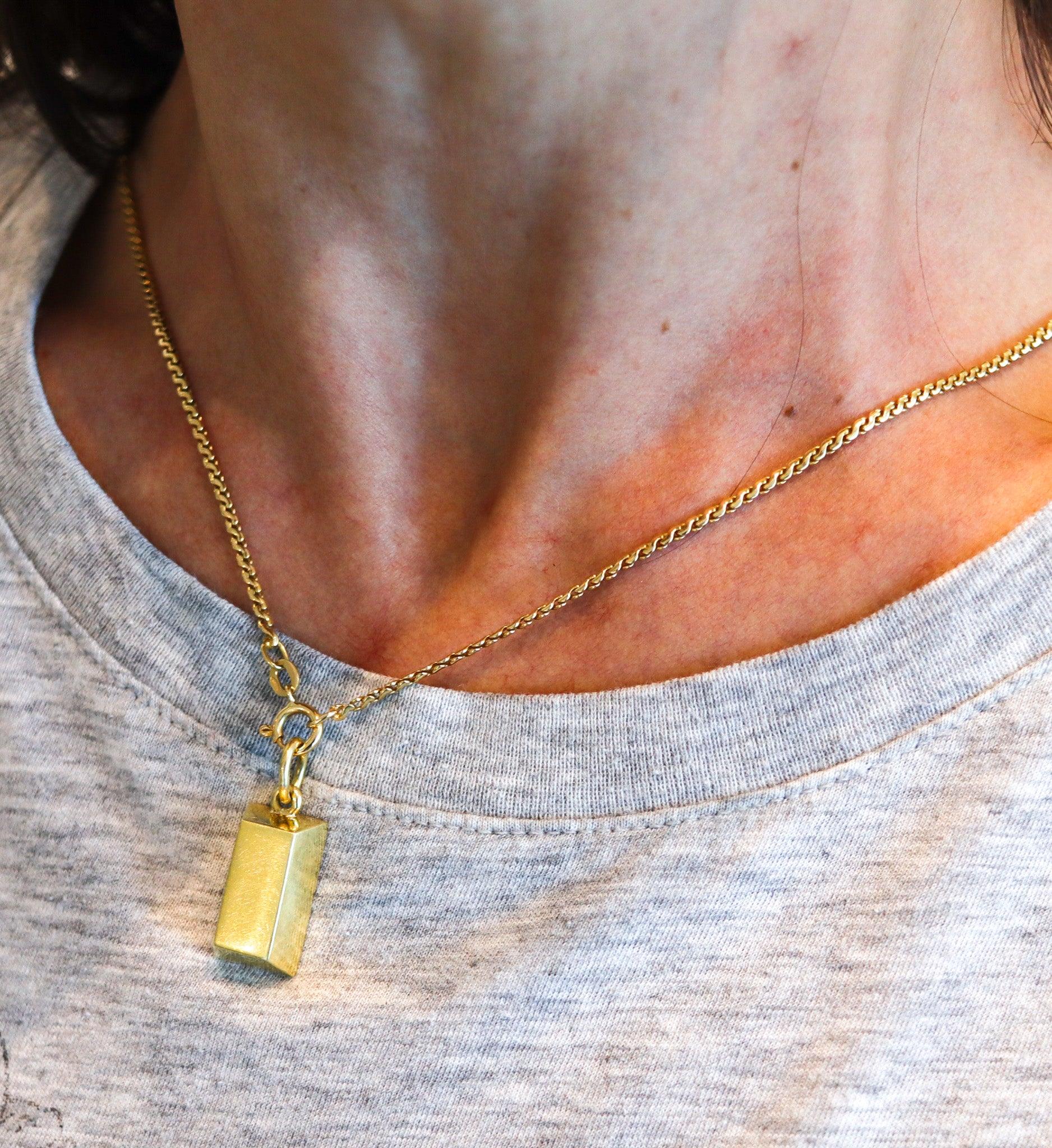 An ingot pendant charm designed by Cartier.

This is a beautiful gold ingot created by the French jewelry house of Cartier, back in the 1970's. This ingot is an iconic piece from the modernism period, and was crafted in solid yellow gold of 18
