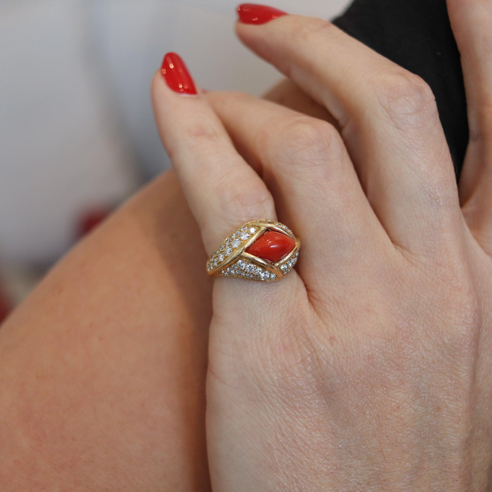 A cocktail ring designed by Cartier.

This stupendous and colorful cocktail ring was created in Paris France by the jewelry house of Cartier, back in the 1970. The ring is rare and was carefully crafted in solid yellow gold of 18 karats with very