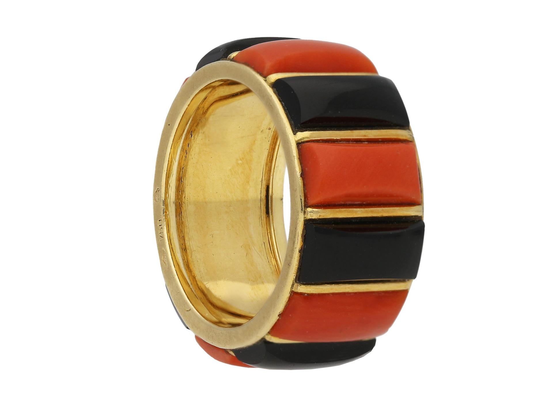 Vintage coral & onyx ring by Cartier. Set with six rectangular cabochon onyx alternated by six rectangular cabochon coral, spaced with fine yellow gold bars and outer border, to a smooth conforming band with ridged inside edging and an approximate