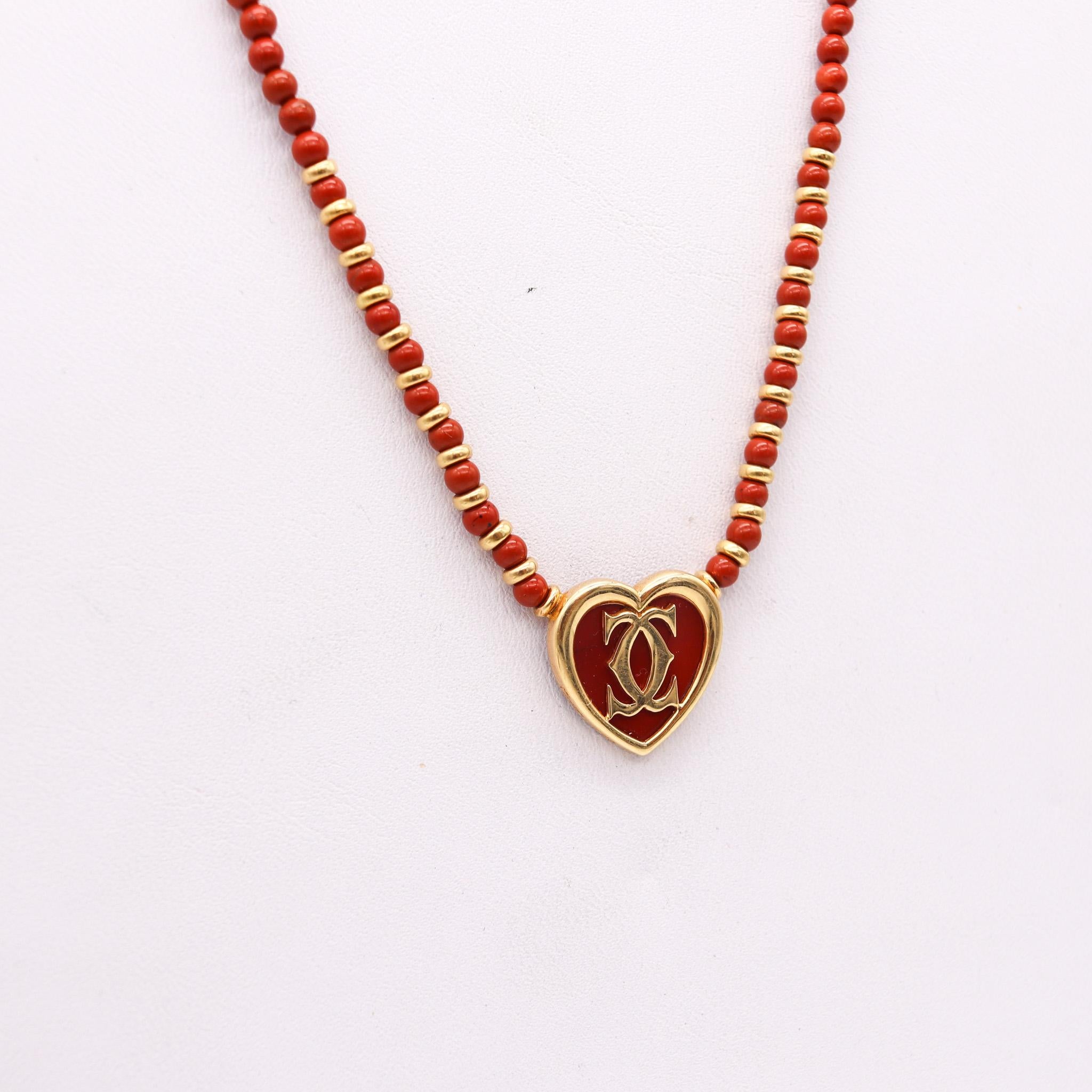 A heart necklace designed by Cartier.

Beautiful contemporary heart necklace, created in Paris France by the jewelry house of Cartier. Crafted with parts made in solid yellow gold of 18 karats and carved pieces from red jasper. Fitted with a crab