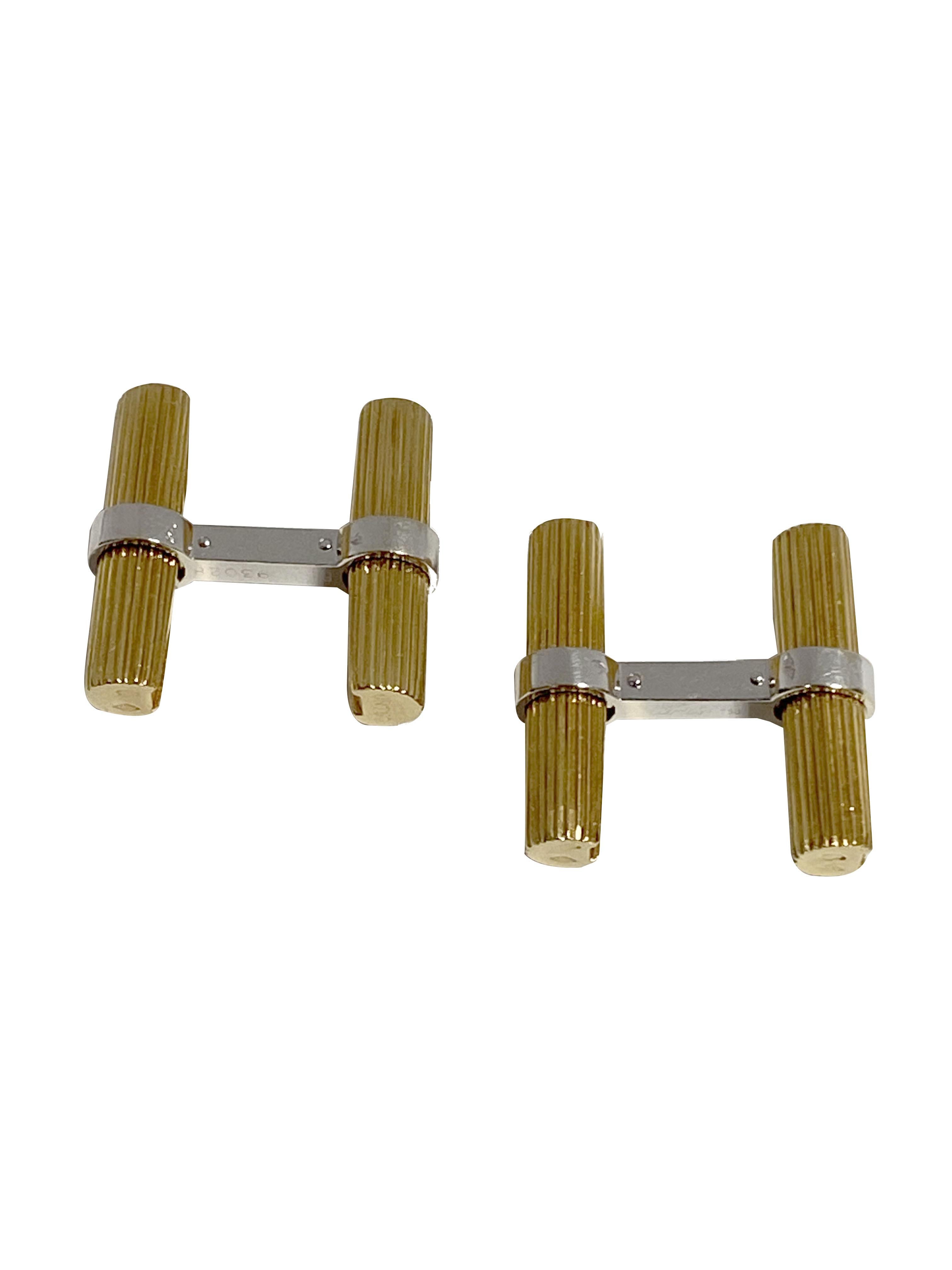 Circa 1970s Cartier Paris 18k Yellow and White Gold Bar Cufflinks, Having a Ribbed Grooved Design, the Bar sections measure 7/8 inch in length. Signed, numbered with French stamps and come in the original Presentation box.