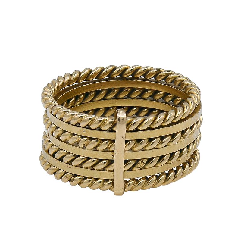 Chic and wearable 7-band ring.  Made, signed and numbered by CARTIER PARIS.  18K yellow gold.  Consists of seven individual bands.  The bands alternate; three are beveled and four are rope pattern; they create a textured, dimensional appearance. 
