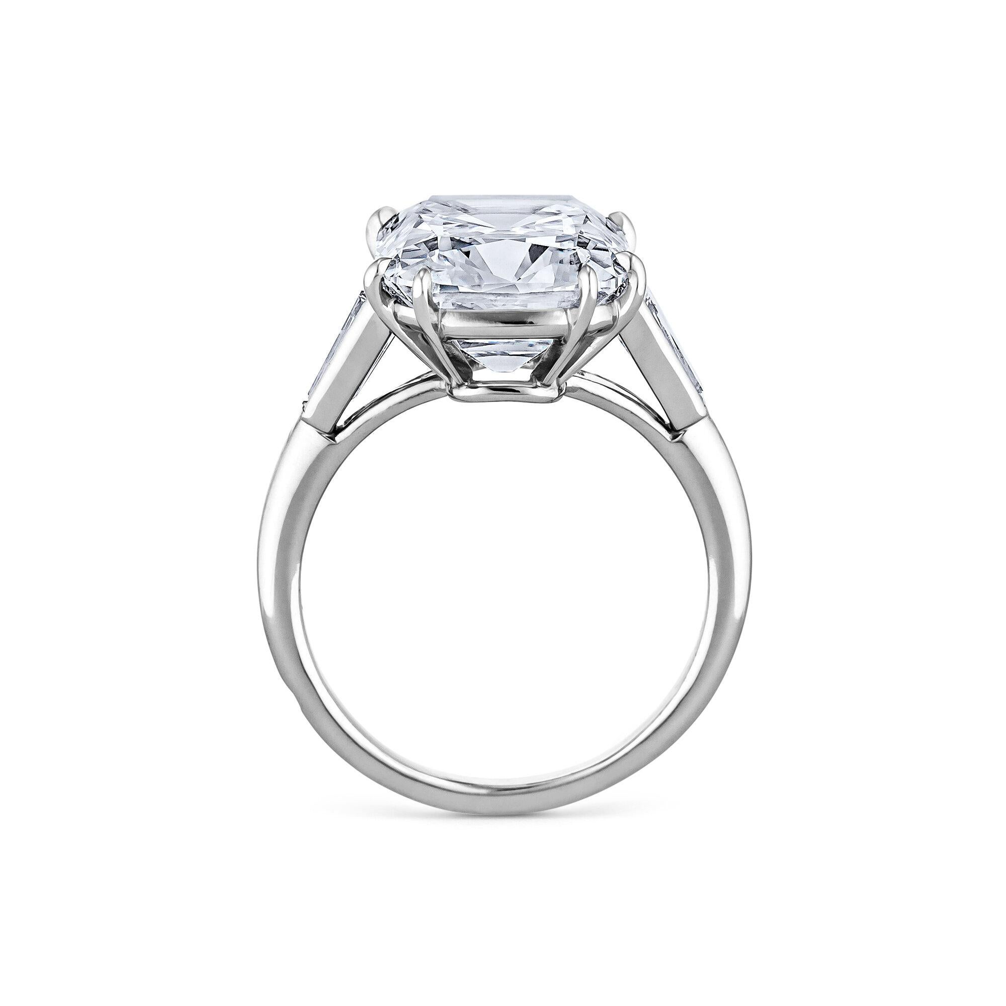 Exuding romance, inner fire, and endless elegance this Cartier Paris Art Deco 7.17 carat cushion cut diamond platinum engagement ring is extraordinary.  Set with two tapered baguettes in a handmade mounting, this timeless jewel is unmatched.  Center