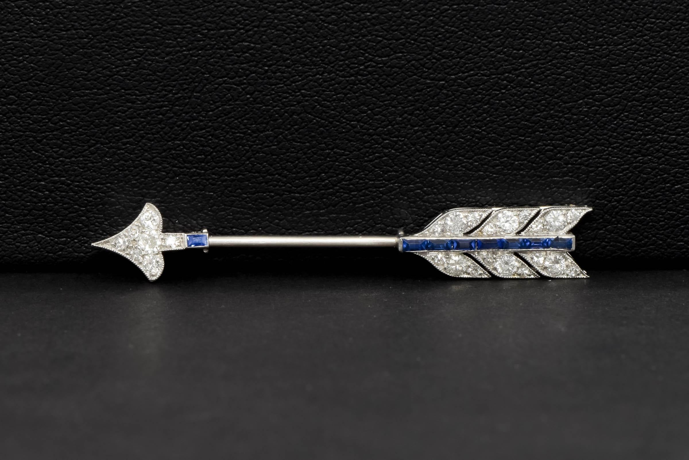 Crafted of platinum, this exquisite 1930’s Cartier  jabot pin brooch features 25 super white and fiery diamonds and 8 marvelously blue sapphires in a graceful, classic Art Deco arrow design. I estimate the diamond weight at approximately .45 carats