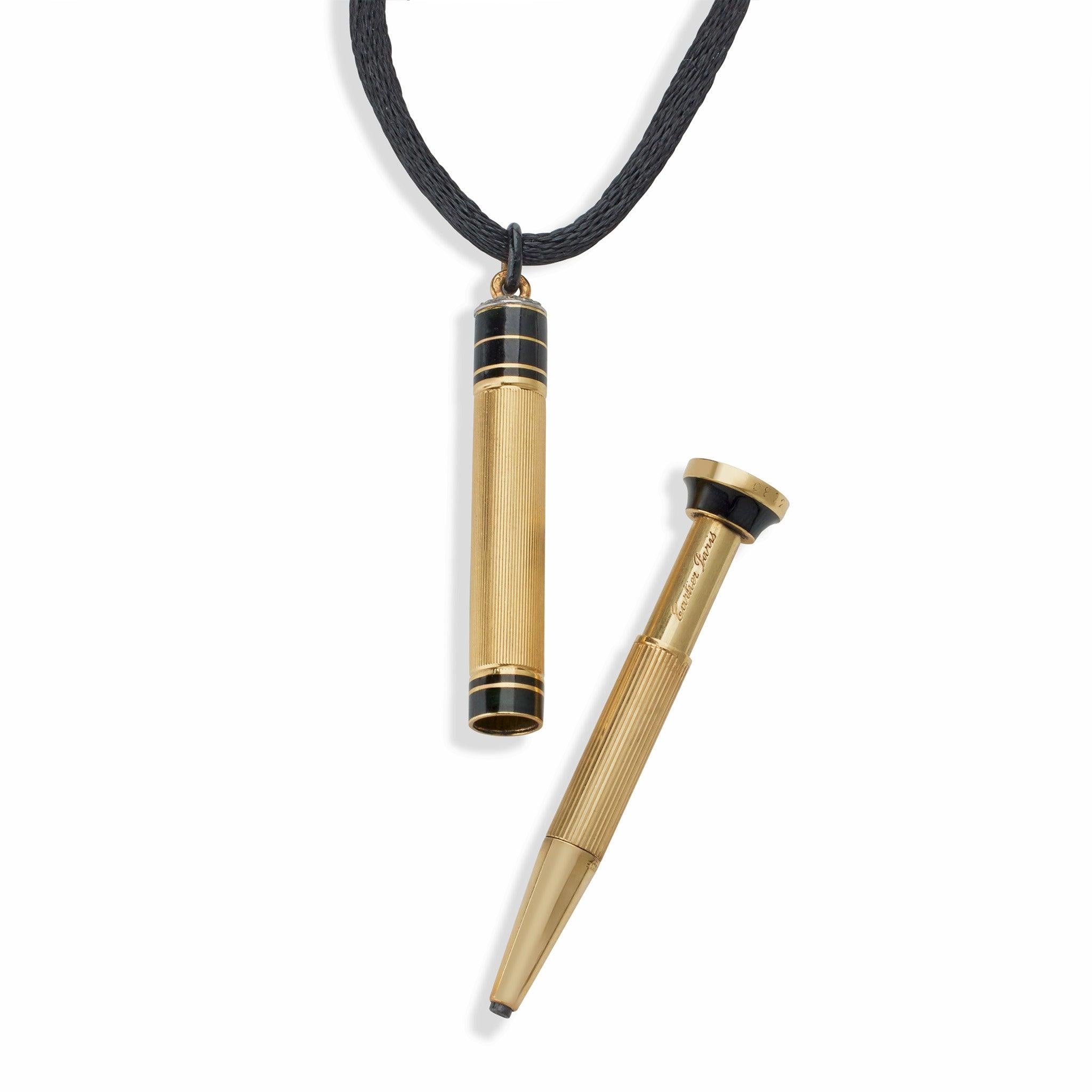 Designed in the late 1920s-1930s by Cartier Paris, this mechanical pencil pendant necklace is composed of 18K gold, enamel and rose-cut diamonds. The reeded telescoping cylinder with bands of black champlevé enamel, base  incised with monogram 