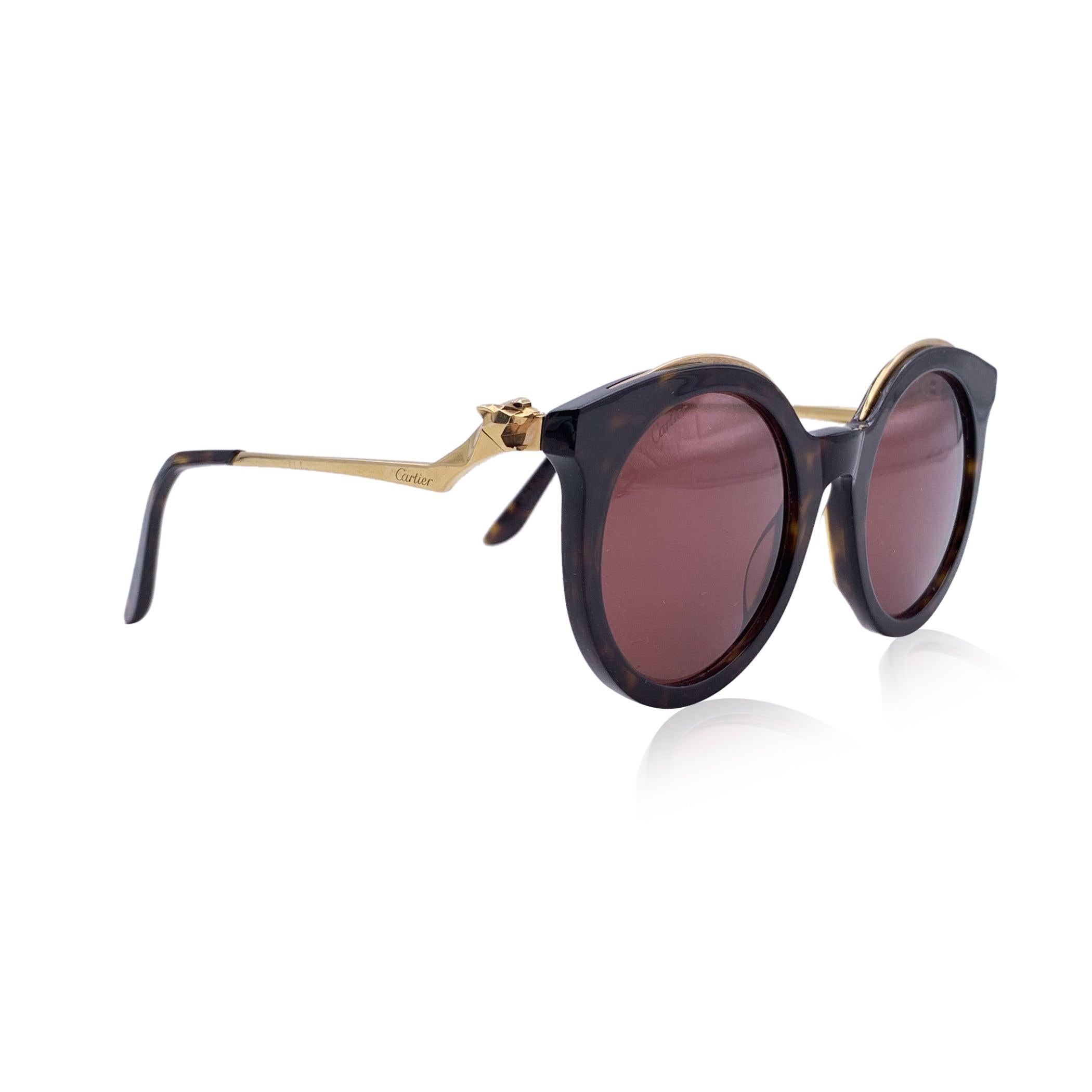 CARTIER CT0118S Cat.3 sunglasses. Black frame with original Cartier colored lenses. Gold color details. Round design. Temples with panther decoration. Made in France Details MATERIAL: Plastic COLOR: Black MODEL: CT0118S GENDER: Unisex Adults COUNTRY