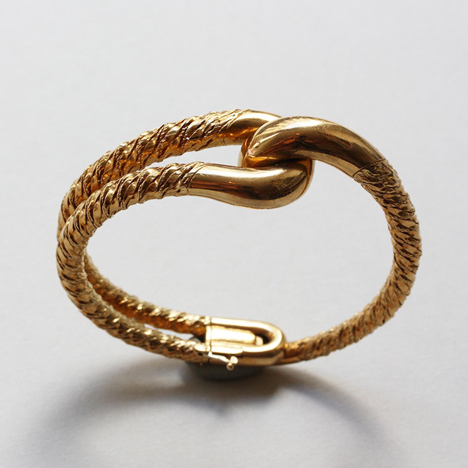 An important 18-carat gold knot bangle, signed and numbered: Cartier Paris, 016 053 by Georges Lenfant. And an 18-carat gold knot pinky ring of twisted thick gold wire. Signed and numbered: Cartier Paris, 36971. Both circa 1970, in their original