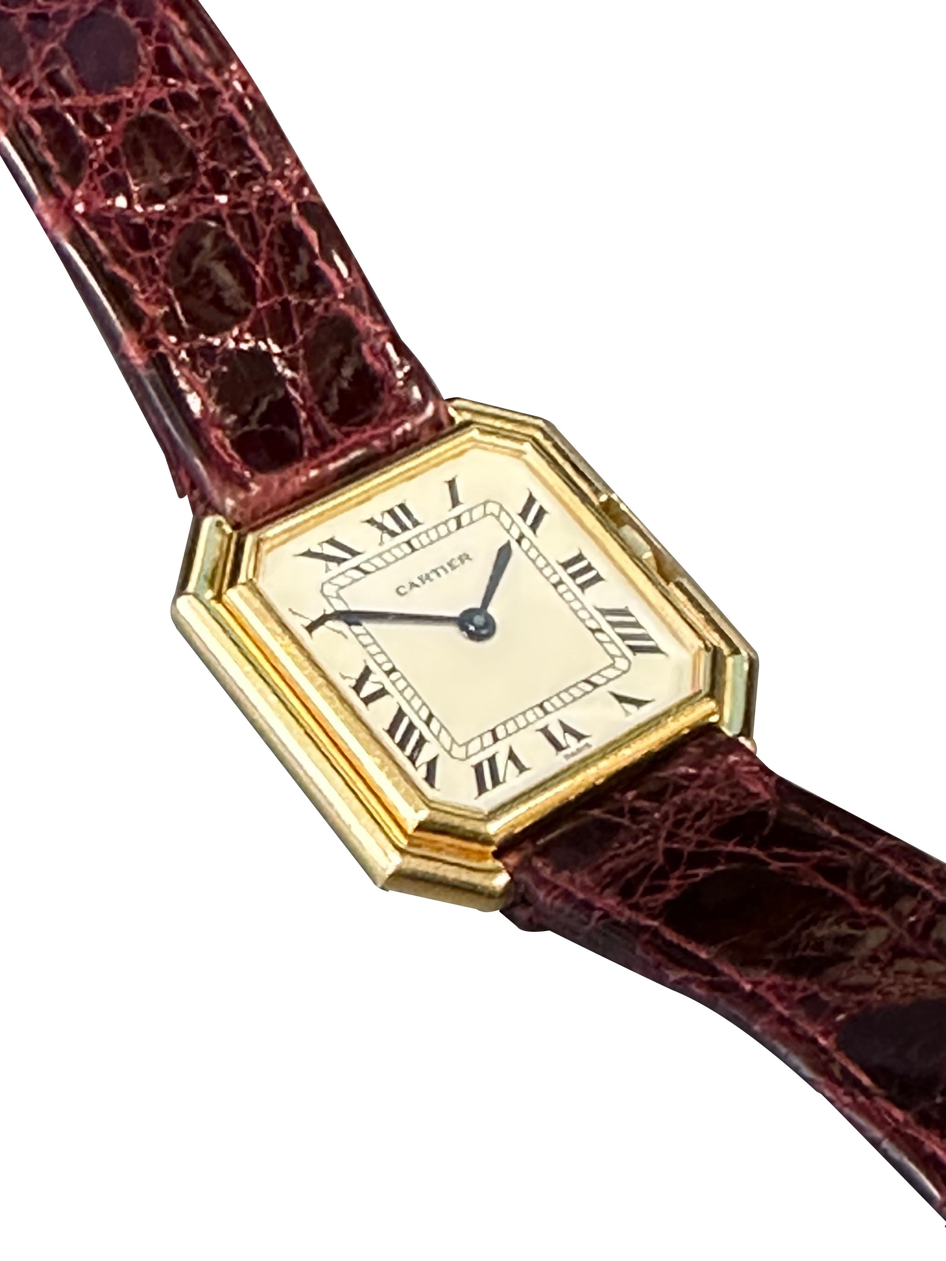Circa 1970s Cartier Paris Centure Wrist Watch,  27 X 27 M.M. 18k Yellow Gold 3 piece stepped case. 17 Jewel Mechanical, manual wind movement, White dial with Black Roman numerals. Original Cartier Burgundy croco Strap with Cartier 18k Tang buckle,