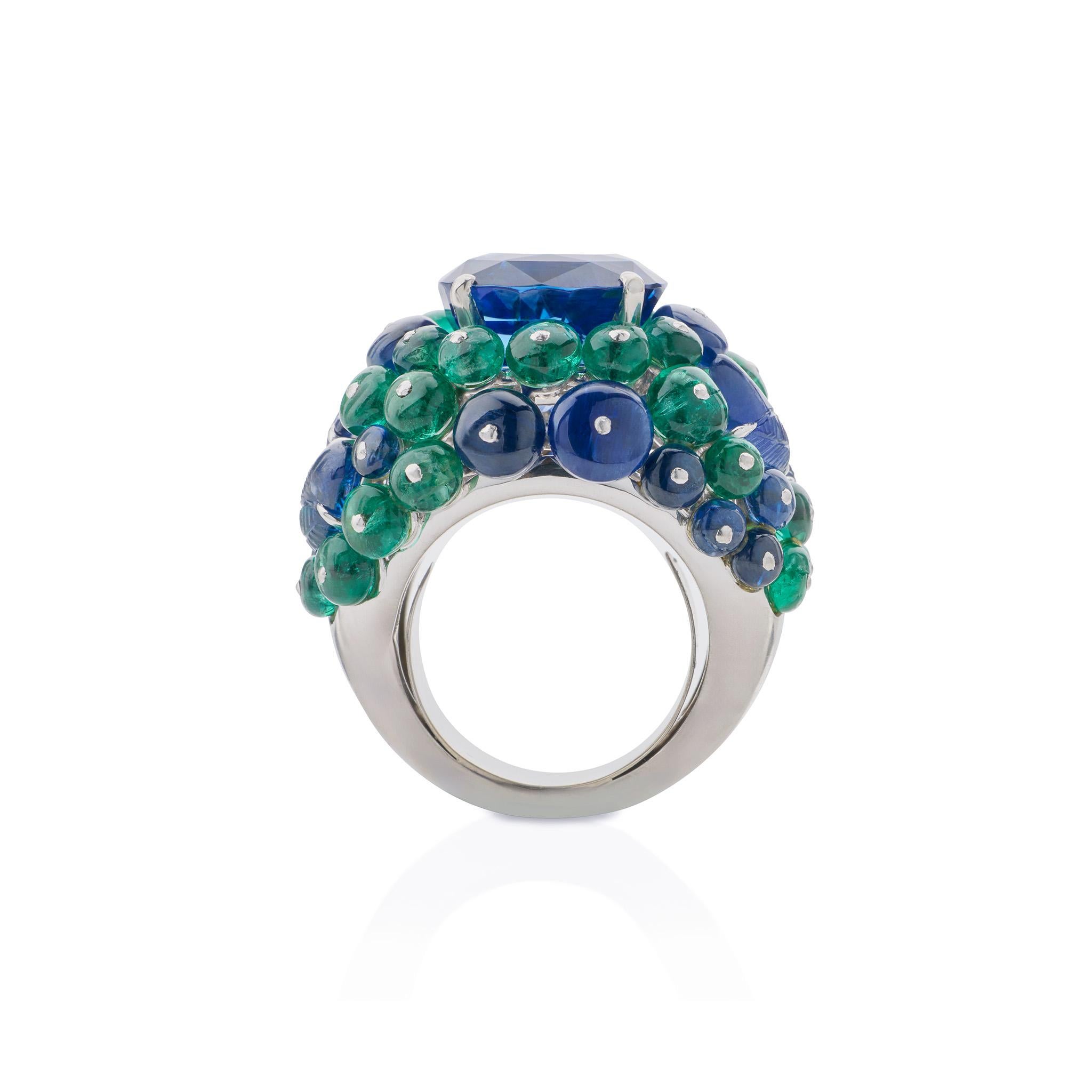 Created by Cartier Paris circa 1997, this beautiful boule ring is set with a 10-carat plus Ceylon sapphire mounted in platinum and 18K gold. The high domed ring centers a Ceylon sapphire weighing 10.98 carats, flanked by pairs of carved sapphire