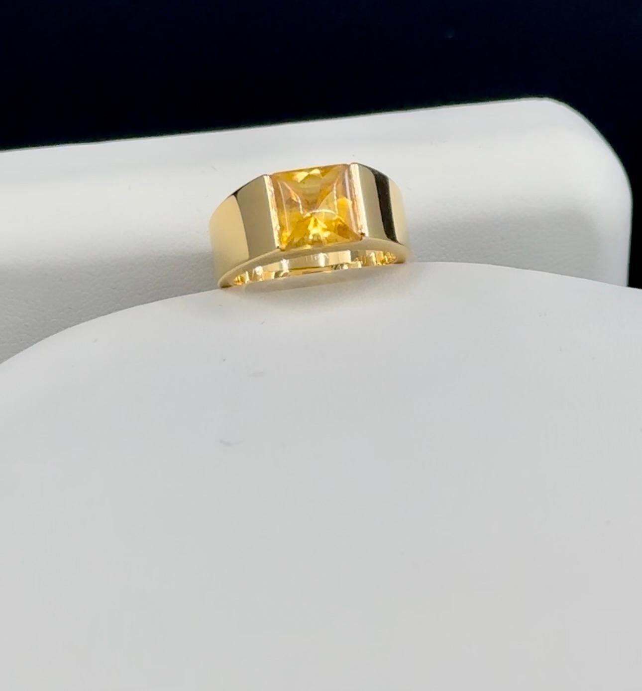 Vintage Cartier Vivid Citrine Tank Band Ring 
Size: 51
1997 Cartier French Hallmarks 750 
The iconic tank ring.
Square Cabochon Citrine Set Open Tension Setting.
Handsome Made in France
18 k Yellow  Gold 
Geometric Band Ring
Dimensions of the