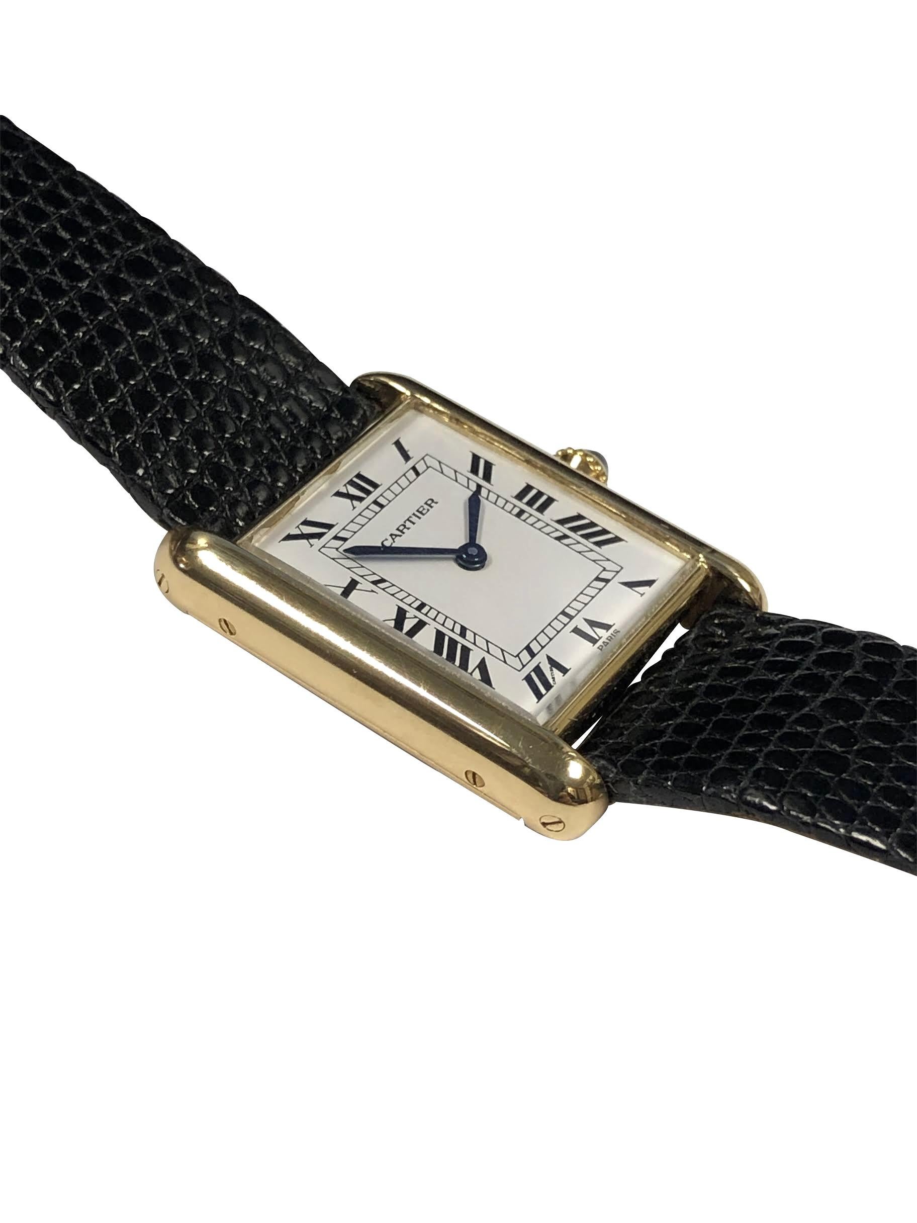 Circa 1985 - 1990 Cartier Classic Tank Wrist Watch, this being the more desirable and harder to find Model with Paris Case and Dial. 18 K Yellow Gold 30 X 24 M.M. 2 Piece case, 17 Jewel, mechanical, Manual wind Cartier movement, White Dial with