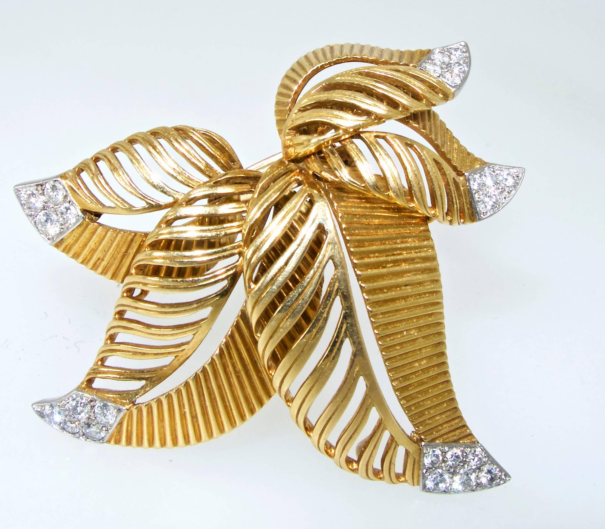 18K and platinum brooch/double-clip possessing fine white diamonds.  There are 24 diamonds weighing approximately .70 cts.  Signed and numbered, this clip is 2.0 inches by 1.75 inches.