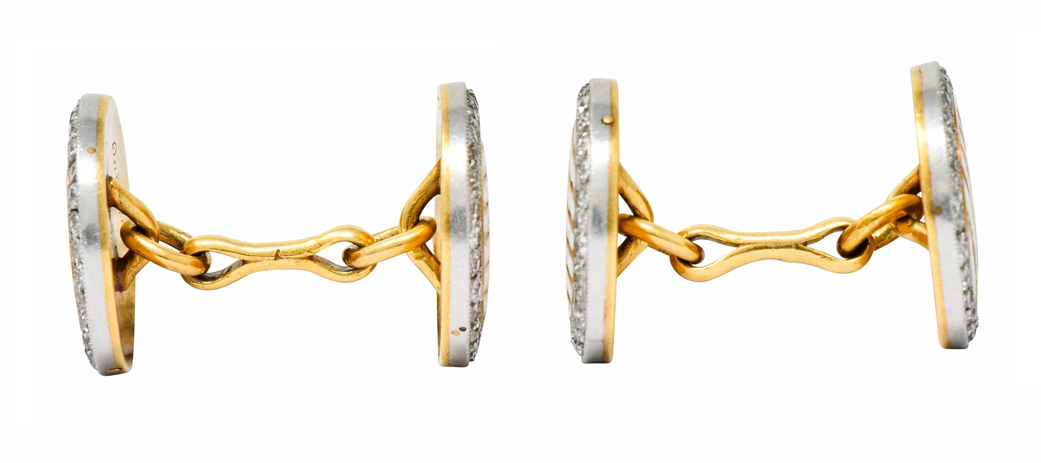 Link style cufflinks with circular disks at each end

Featuring a striped design of white enamel alternating with engraved gold; exhibiting minimal loss

Surrounded by a halo of single cut diamonds weighing in total approximately 1.25 carats; G to J