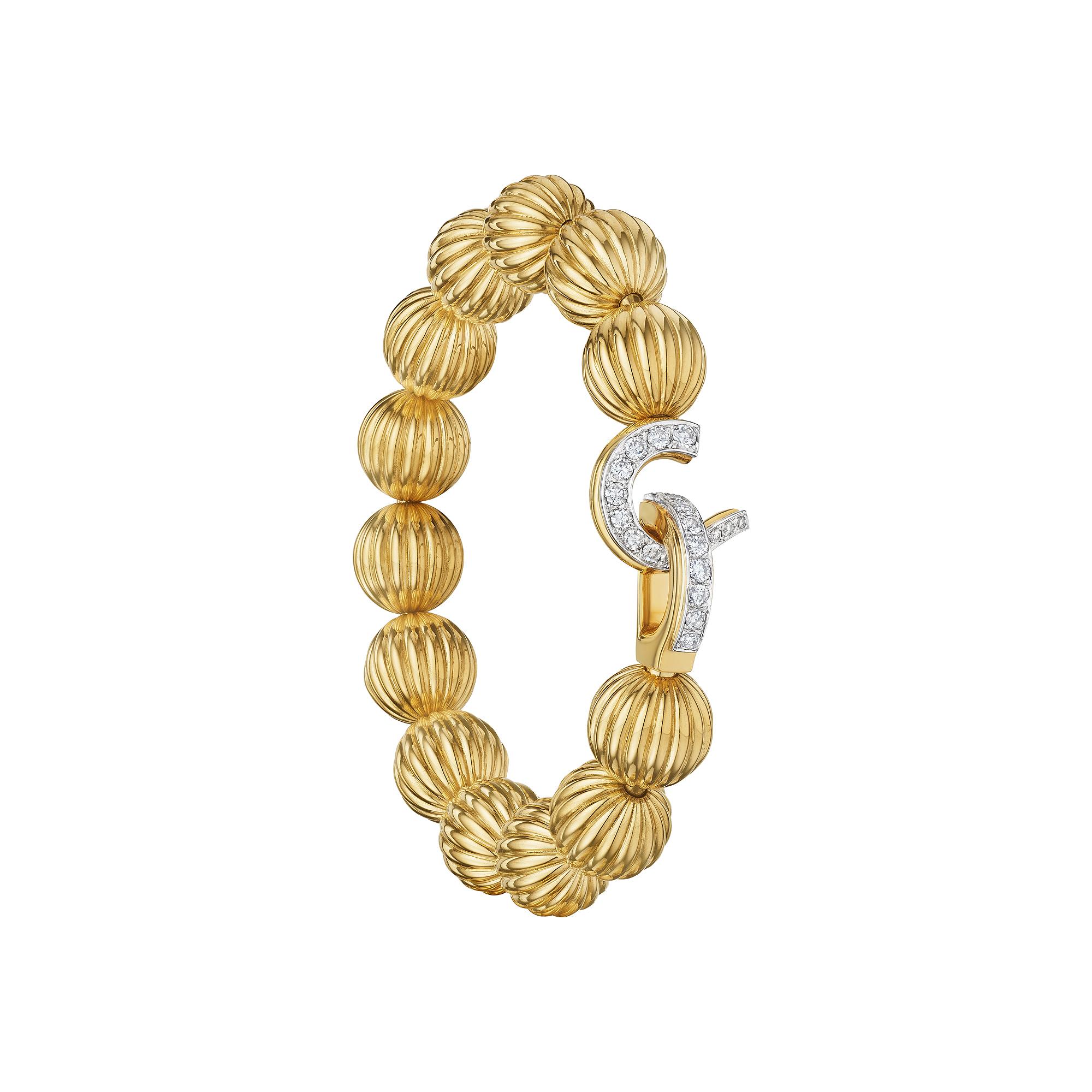 Elegantly dancing around the wrist these 13 carved gold melon shaped beads create a compelling Cartier Paris vintage bracelet that is both collectible and hard to resist.  The eye-catching diamond hook and eye closure completes the one-of-a-kind