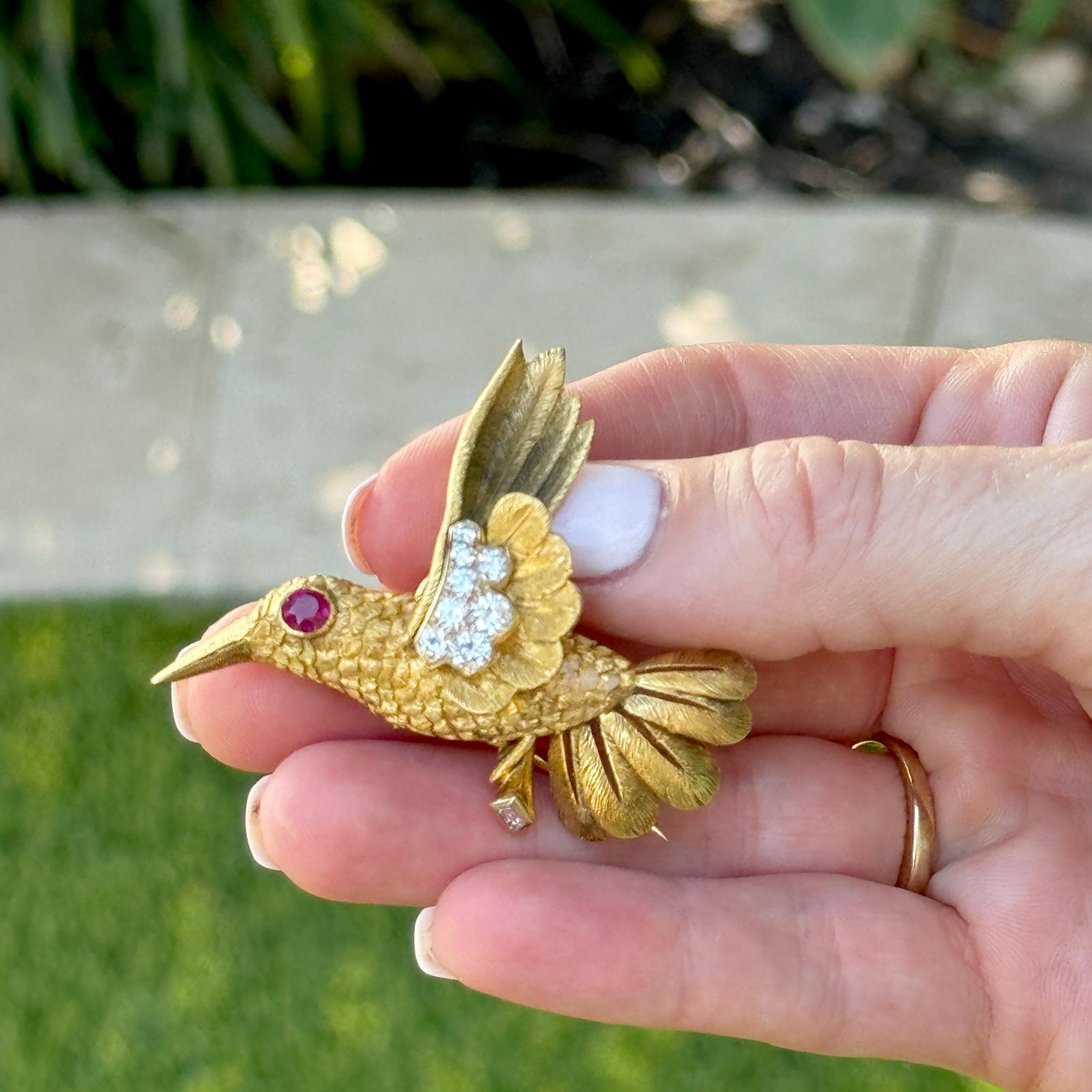 The Cartier Paris Diamond Ruby Hummingbird Brooch Pendant is a luxurious and versatile piece of fine jewelry. Meticulously crafted by Cartier, this exquisite brooch features a beautifully detailed hummingbird adorned with 8 sparkling diamonds