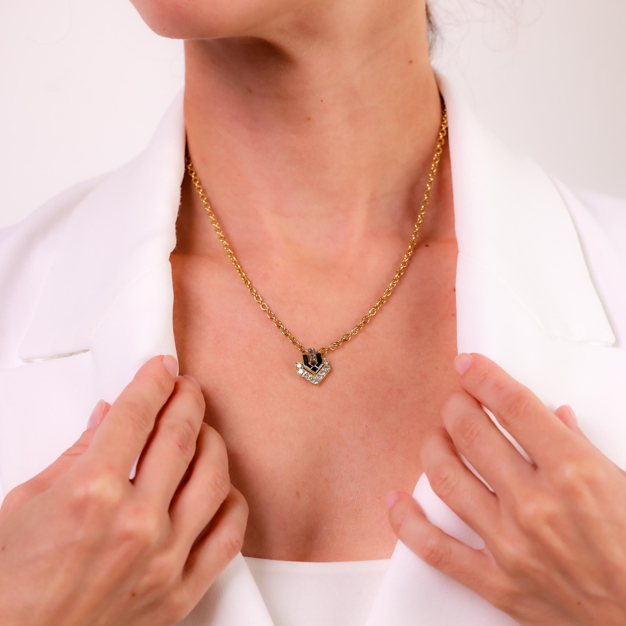 This vintage Cartier Paris necklace dazzles with diamonds and sapphires, elegantly set in luxurious 18k yellow gold, showcasing timeless sophistication.

Brand: Cartier Paris
Center stone: 9 round brilliant and 2 baguette cut diamonds 
Weight: