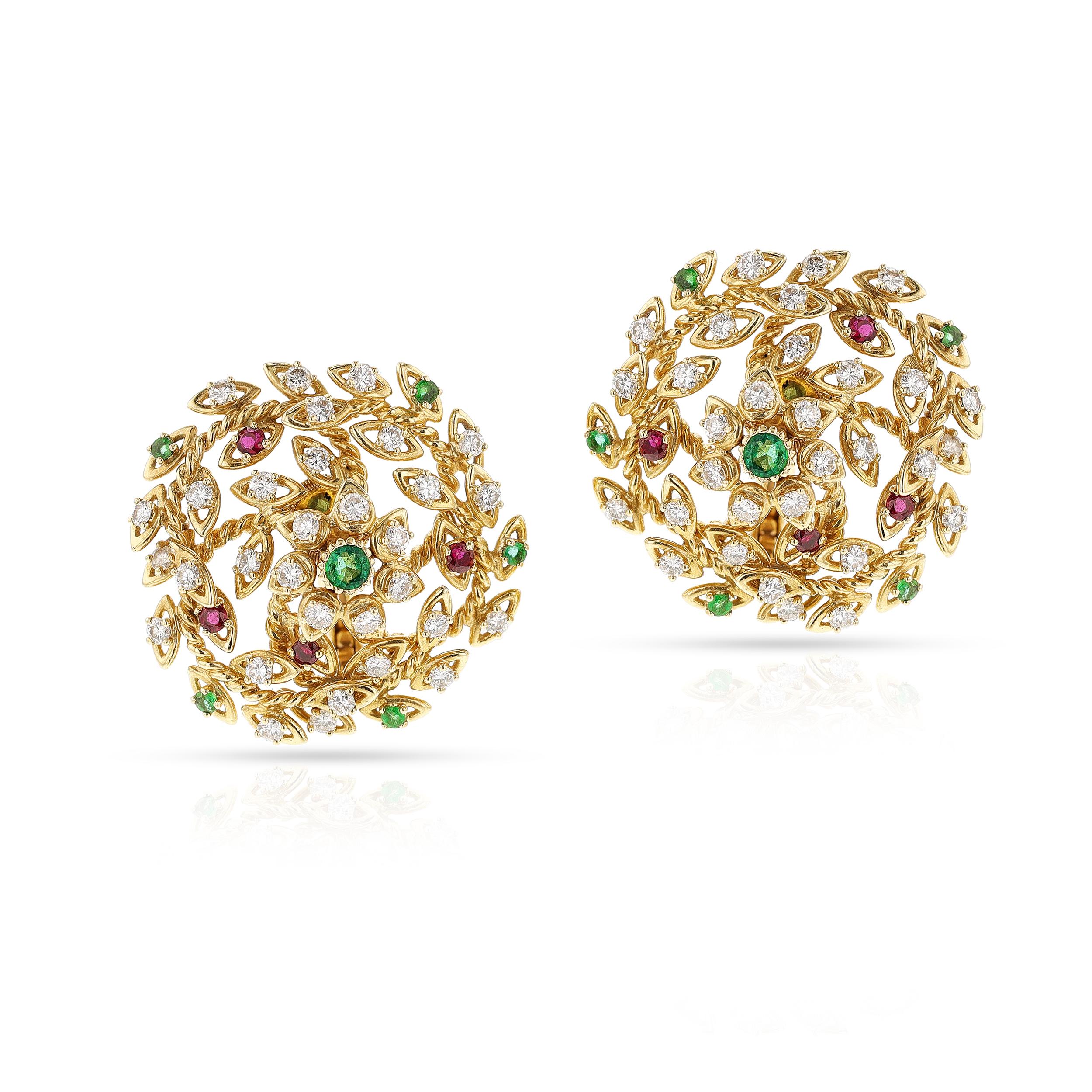 A pair of Cartier Paris Diamond, Emerald and Ruby Earrings made in 18k Gold. Signed and numbered. The diamonds are appx. 3.60 carats, D-E-F color, the center emeralds are appx. 0.50 cts. total, accented with small emeralds and rubies. The diameter