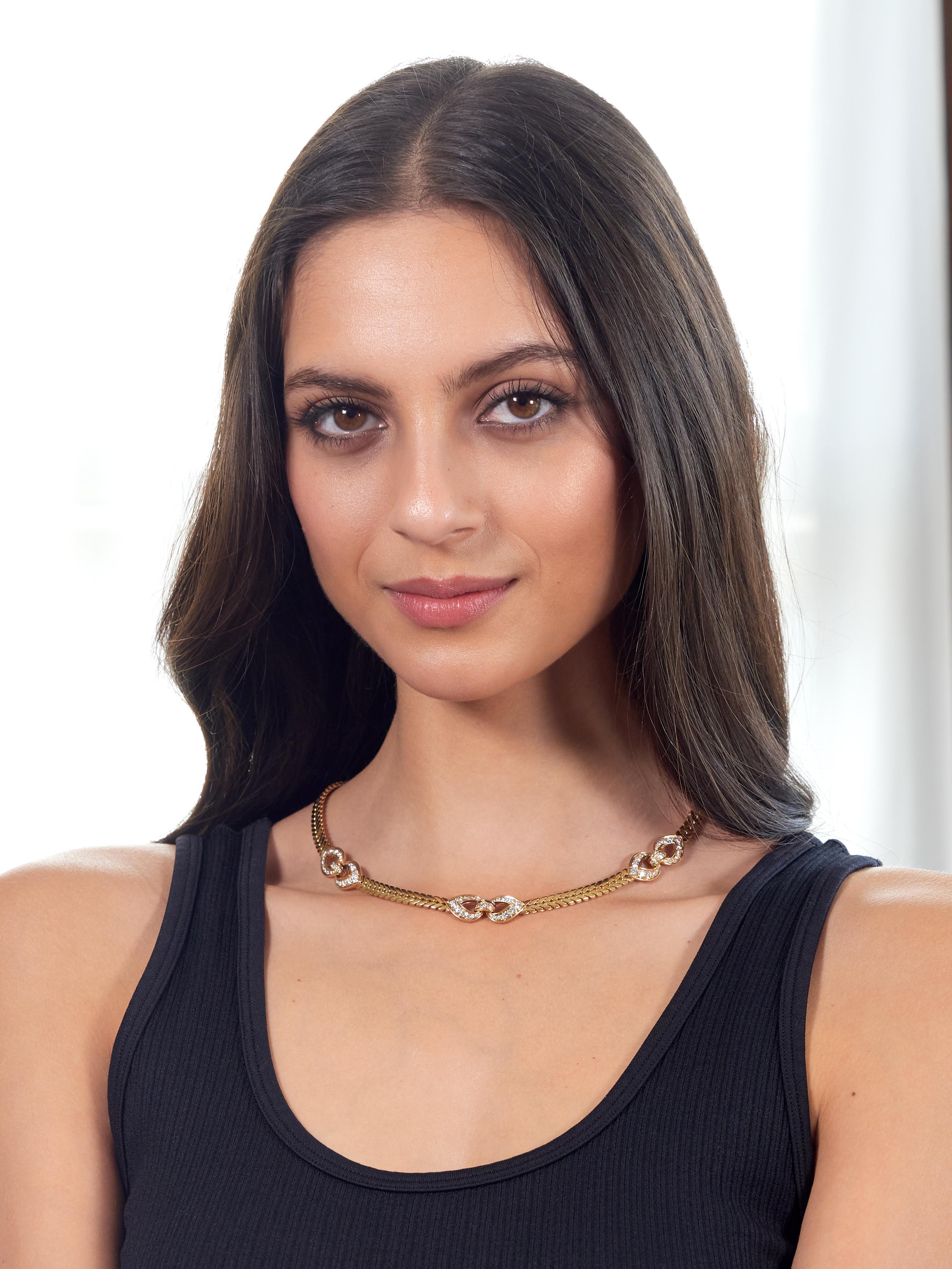Comprised of wheat style chain featuring three looped stations
Bead set with round brilliant cut diamonds throughout
Weighing approximately 3.45 carats total
E-F color with VS1 clarity
Completed by press release closure with hinged safety
Stamped