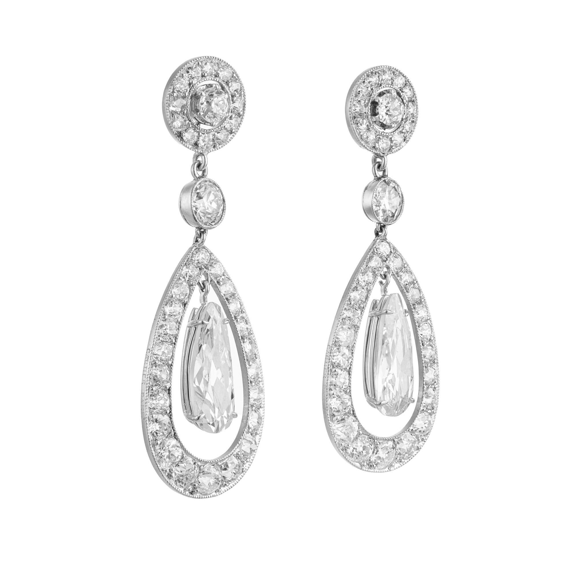 Sensational Early 1900's Cartier Paris diamond dangle earrings. These stunning earrings are set with 2 pear shaped diamonds with a total weight of 2.14cts. that dangle from custom cut halos of old European cut diamond halos. These earrings have a