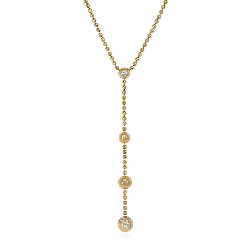 A gold Nouvelle Vague Draperie necklace comprised of ball-chain and a tapering diamond set bead pendant, in 18k.  Cartier, Paris, #I18296. Atw 0.35 ct. diamonds.
Matching earrings available; please see separate listing

Dimensions: 15