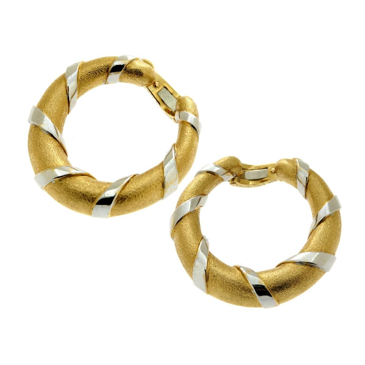 A fabulous pair of Cartier hoop earrings featuring a unique textured finish on the yellow gold followed by smooth 18k white gold ribbons for the perfect contrast.

The earrings measure 1.22