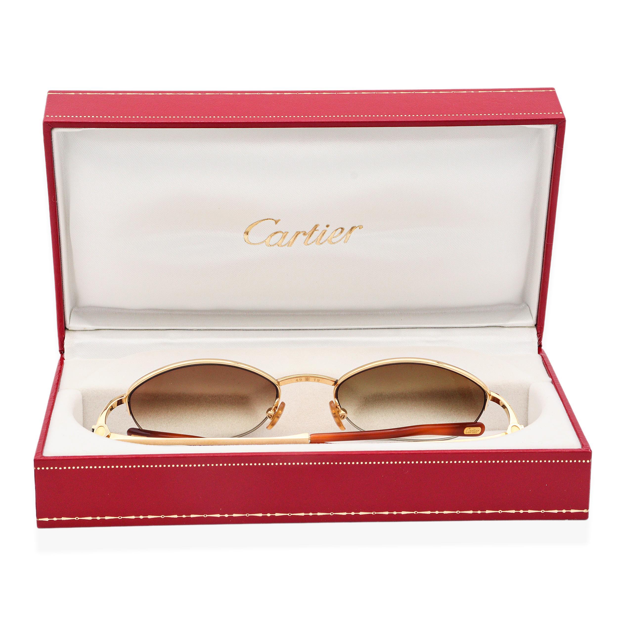 Cartier Paris Gold Plated Sunglasses with Olive Gradient Lenses. These luxurious sunglasses feature a refined gold frame paired with elegant olive gradient lenses, offering both style and sun protection. Designed by Cartier Paris, they showcase the