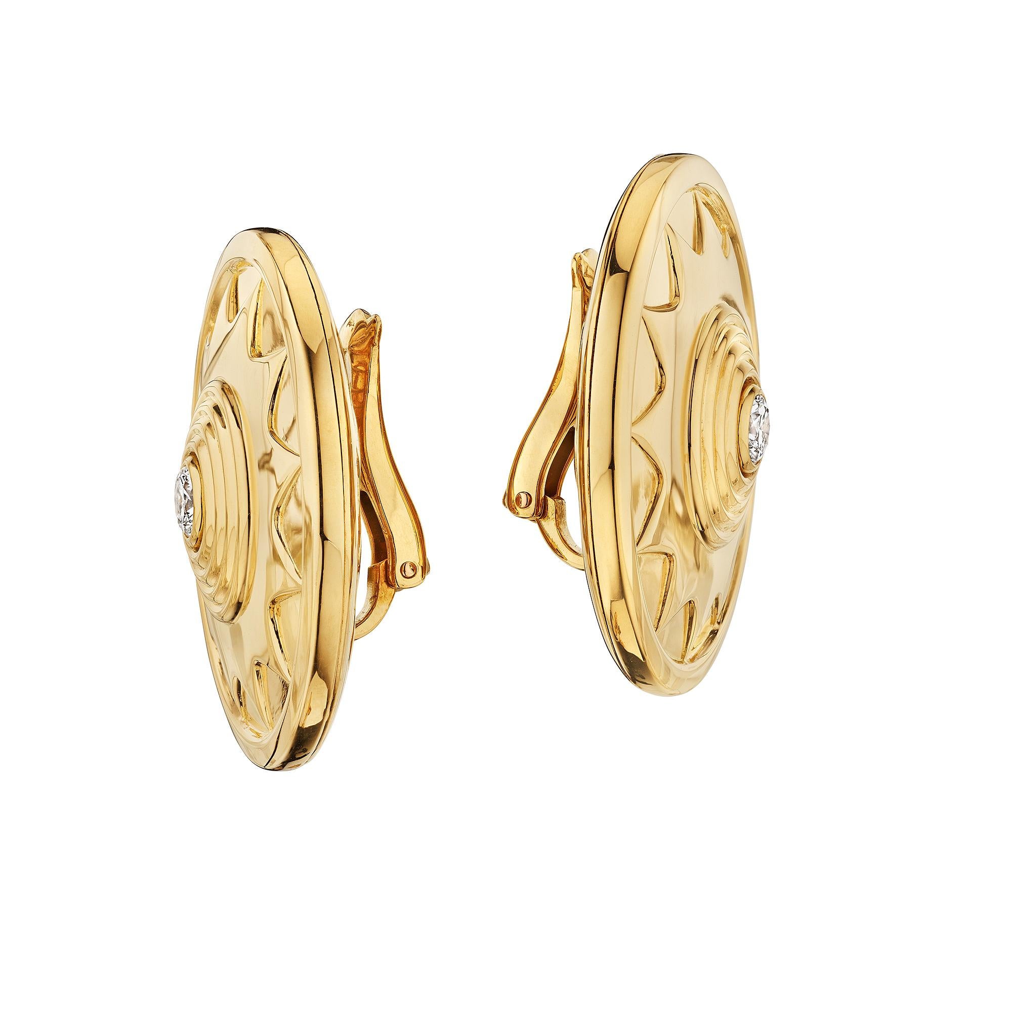 Sunshine symbolizes happiness, warmth, and positivity.  These Cartier Paris modernist diamond 18 karat yellow gold disc clip earrings exudes light and joyfulness.  Signed Cartier.  Circa 1990's.  Center round cut diamonds total weight .50 carats.  1