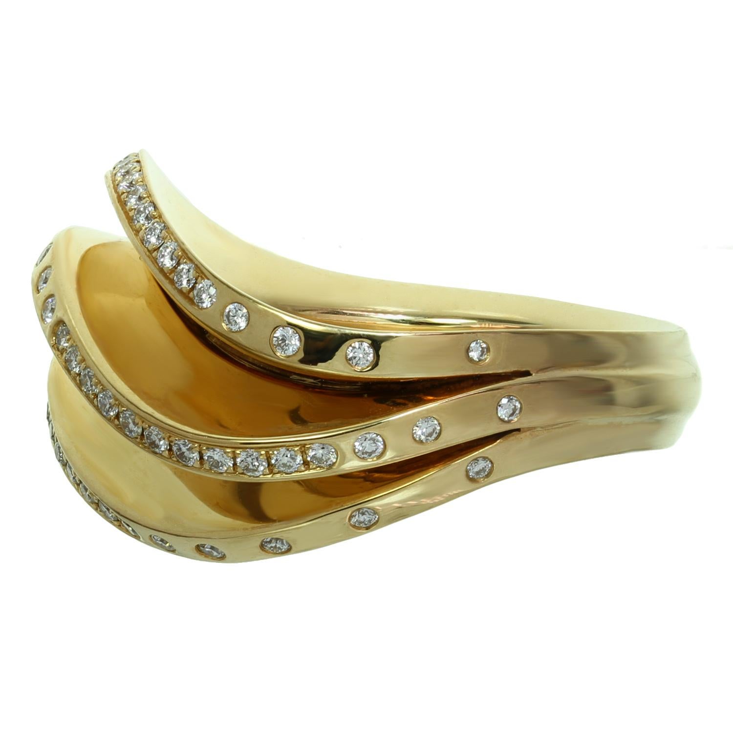 This stunning Cartier Fan ring from the chic Paris Nouvelle Vague collection is crafted in 18k yellow gold and set with D-F VVS1-VVS2 brilliant-cut round diamonds. Made in France circa 2013. Measurements: 0.55