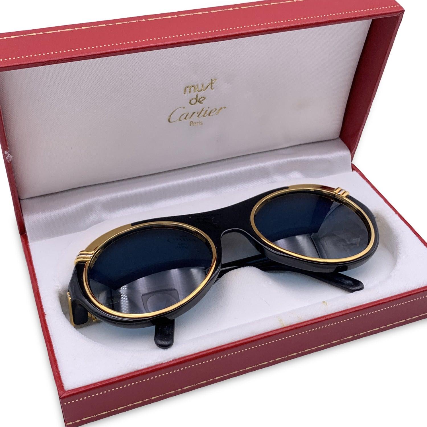 Vintage rare CARTIER Paris - DIABOLO. Very rare Sunglasses from the 1991. Black round acetate frame and 18K Gold accents. Serial reference: 1007185. New 100% UV protection lenses in blue color. They will come with its original CARTIER red case. Made