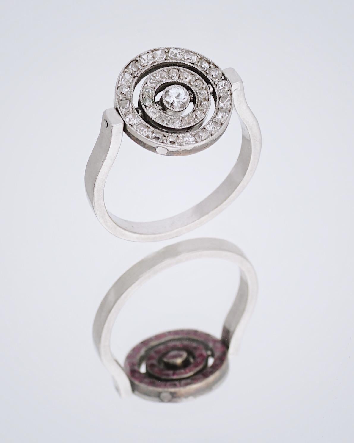 Cartier, Paris
Diamond & Ruby Swivelling Ring, C. 1910

From the Belle Epoque period, this early century (C.1910) ring is set with three raws spaced with calibre rubies to one side and old mine cut diamonds on the other. It is playful and can be
