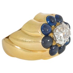 Cartier, bague rétro à grappe en or, saphir cabochon et diamants, Paris