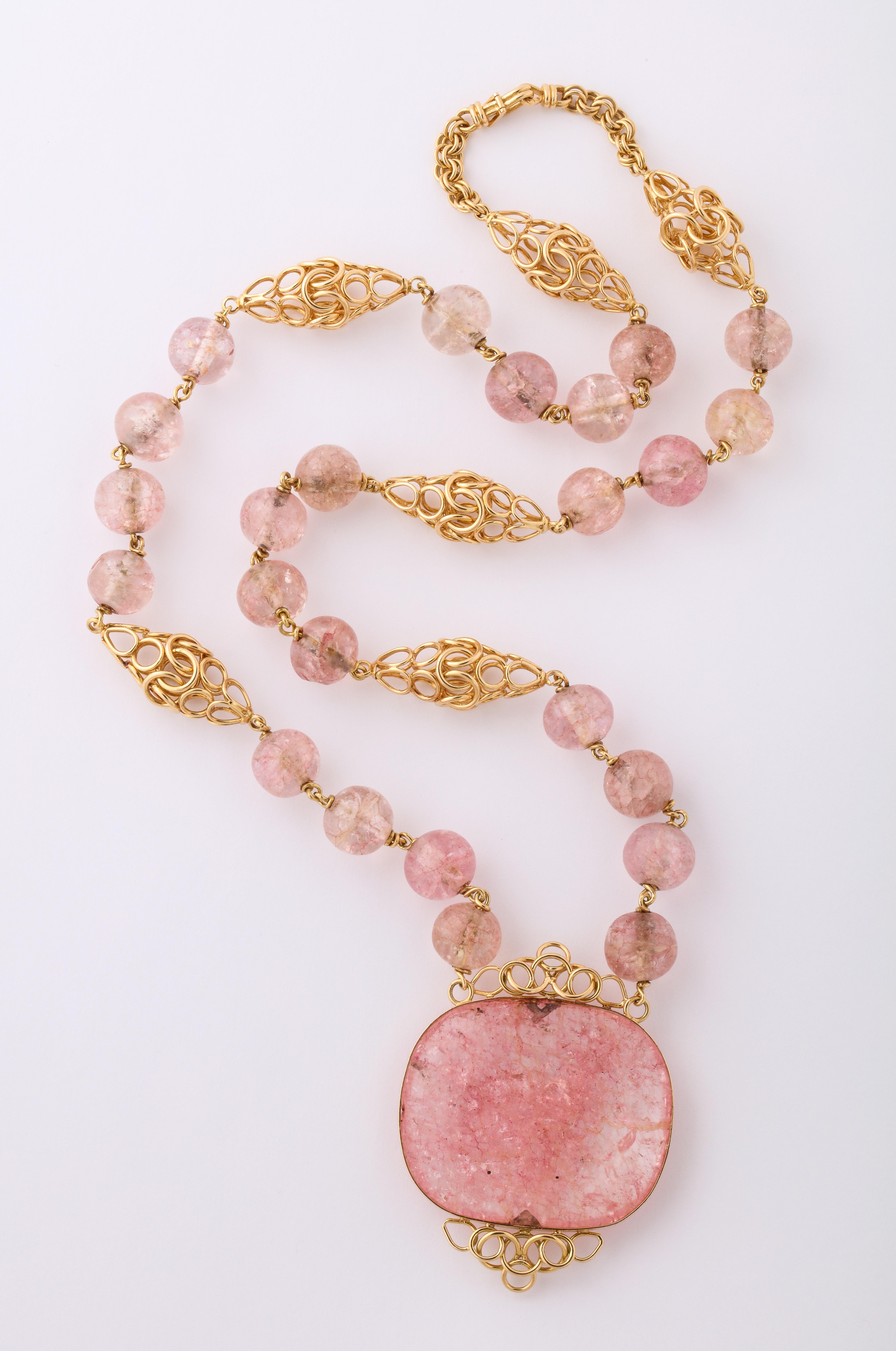 Cartier Paris Rose Quartz handmade necklace, circa 1980.  18k Yellow Gold, 126 grams.  28 inches long x 1 3/4 inches wide and 1/2 inch deep.  Hallmarks on the catch.

Materials:
18k Yellow Gold, 126 grams

Stones:
Rose Quartz

Measurements:
28