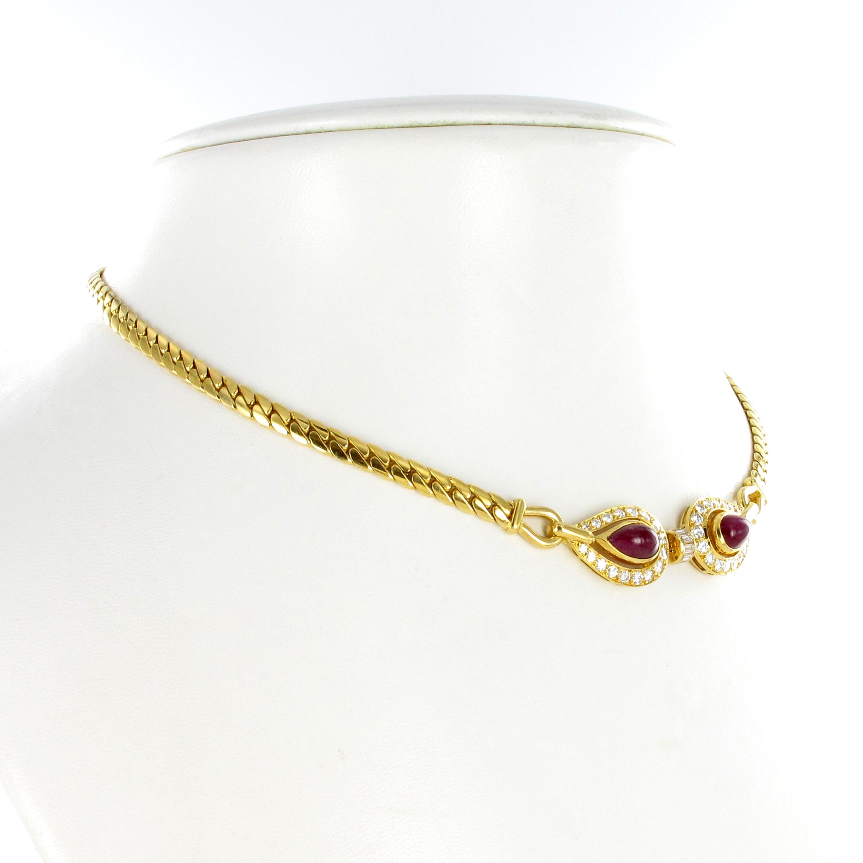 This elegant necklace by Cartier Paris features two pear shaped cabochon rubies of approximately 3.20 carats total weight. Accented by 34 brilliant cut diamonds of F/H color and vs clarity, total weight approximately 0.64 carats, and 6 baguette