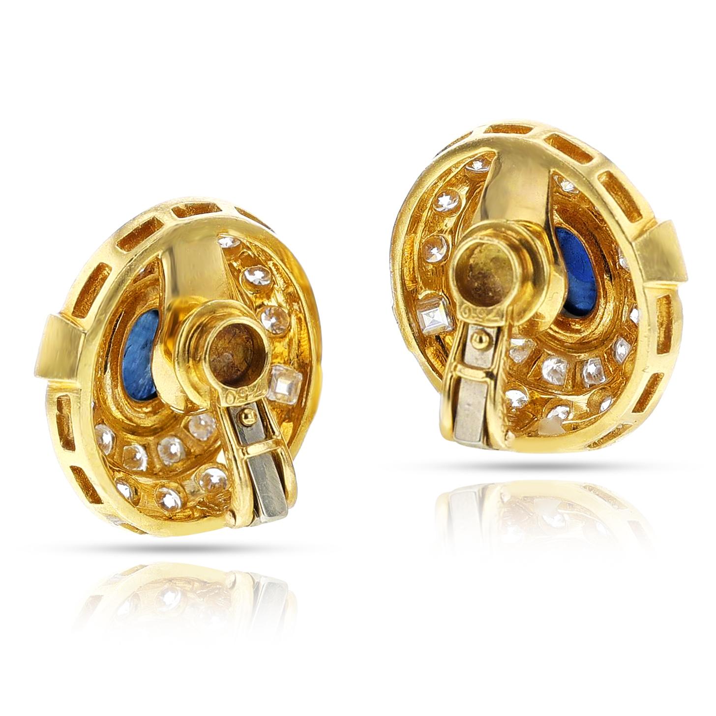 A pair of Cartier Paris Diamond and Sapphire Cabochon Earrings made in 18k yellow gold. The two sapphire cabochons weigh appx. 4.25 carats and the diamonds weigh appx. 4.95 carats. Signed Cartier Paris, numbered.  French Hallmarks, Makers Mark.