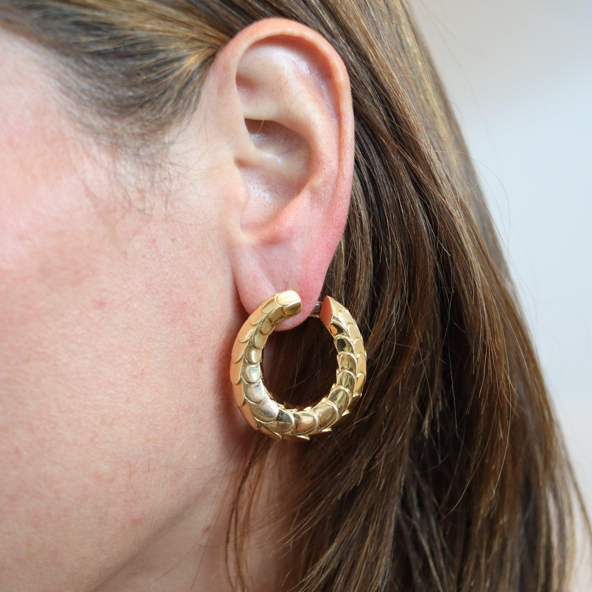Large hoops earrings designed by Cartier.

These gorgeous hoops earrings are a classic, created in Paris France by the jewelry house of Cartier, back in the late 1970. They have been crafted as a left and right pair with a beautiful, scalloped