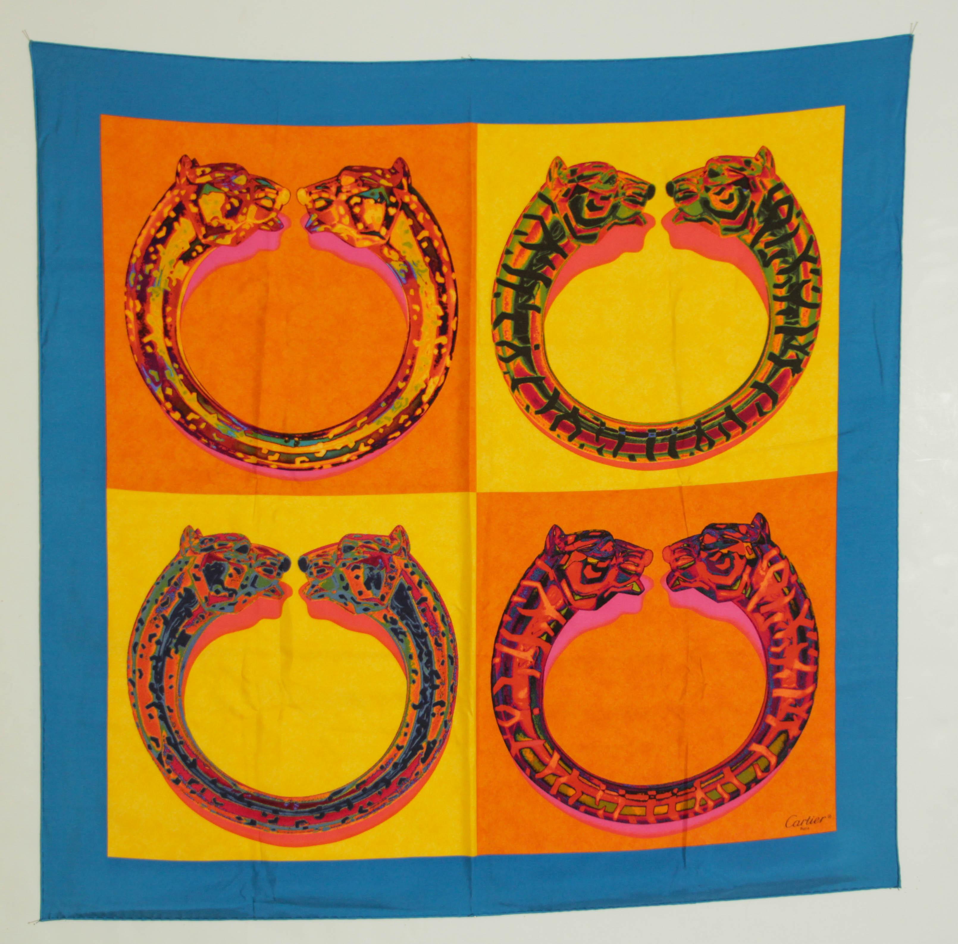 CARTIER  Paris in Box Elegant Silk Scarf .
Bordure bleue sur fond jaune or et orange à la grâce féline et sensuelle, les bracelets légendaires de Cartier. 
L'écharpe en soie imprimée de Cartier est une pièce étonnante qui rend hommage aux bracelets