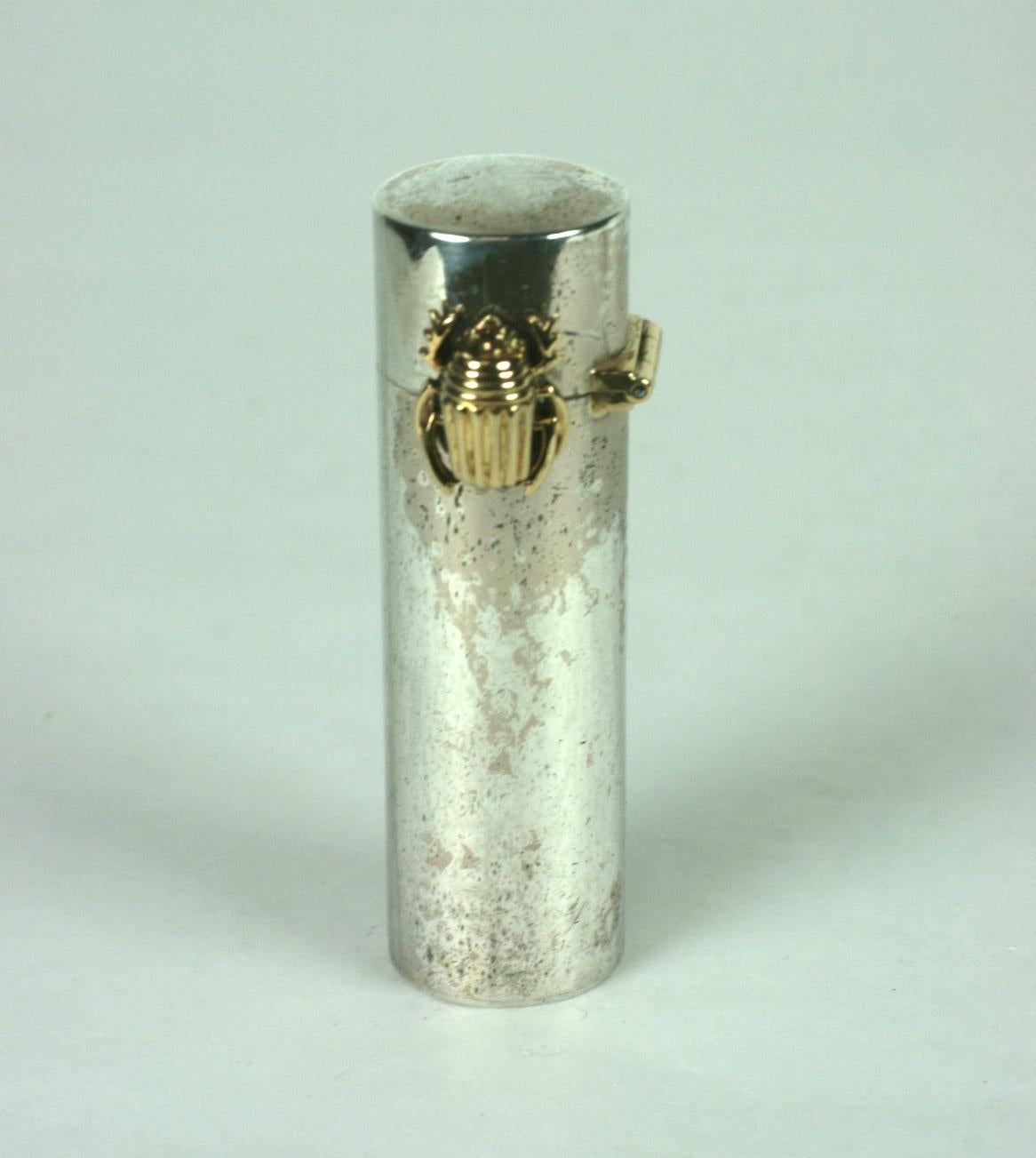 Beautiful Cartier, Paris Sterling and Gold Lipstick circa 1940's, France. To open, lift lid and slide 18k gold Deco scarab to the left to raise lipstick. French hallmarks for metal content on inner edge. 
Original lipstick.  2  3/8