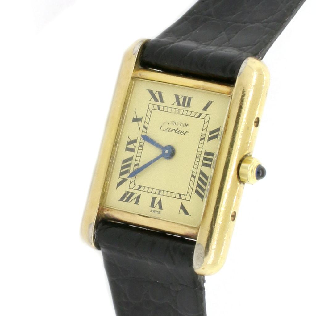 Cartier Paris Tank Small Ladies Watch, 366001. Quartz battery movement. Gold plated 21mm case. Push-down crown. Factory champagne dial with Roman numerals. Functions: hours, and minutes. Aftermarket black crocodile leather strap with gold plated