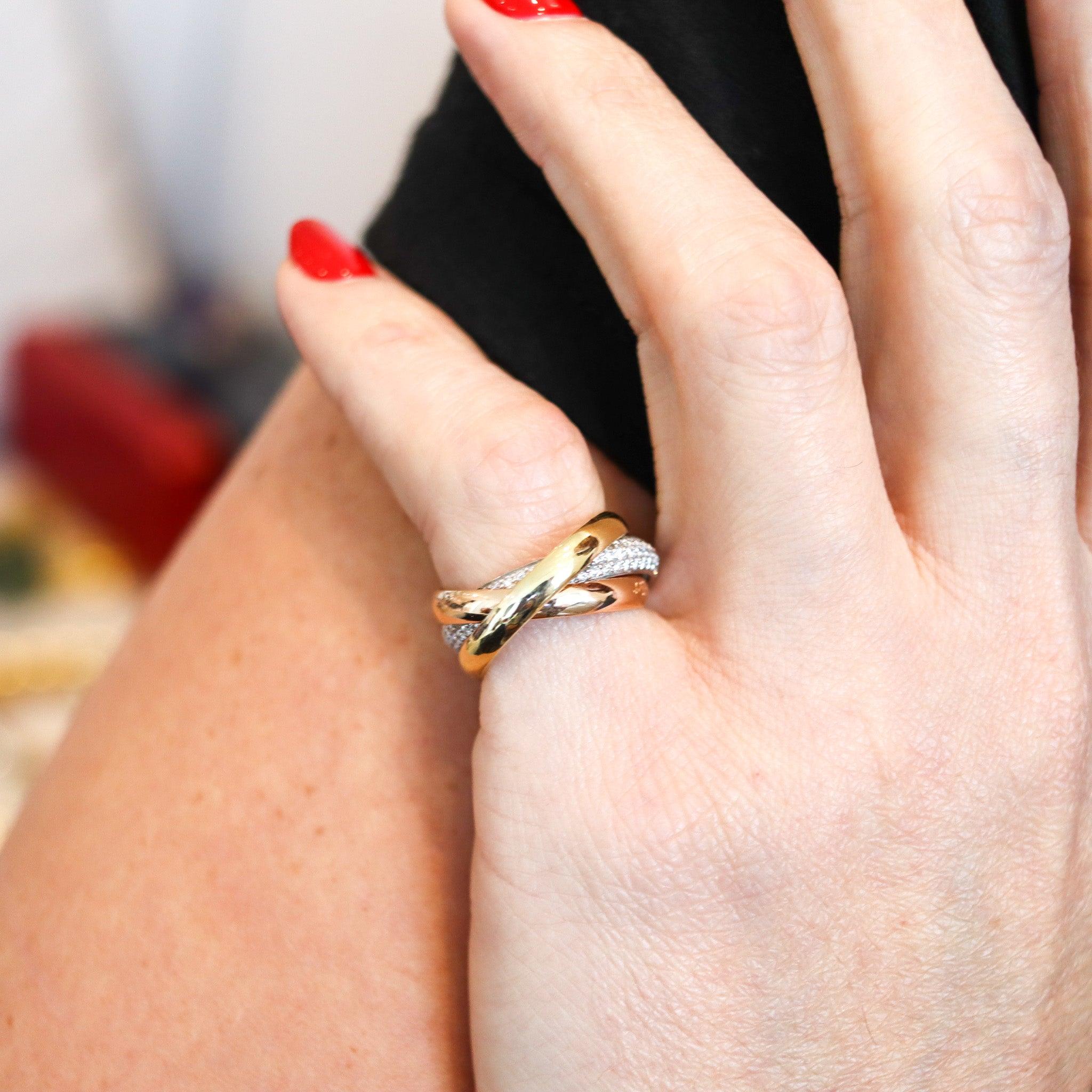 A trinity ring with diamonds designed by Cartier.

This is the iconic Trinity ring, originally created during the art deco period in Paris France by the house of Cartier. The Trinity ring is a classic with over one hundred years of history and