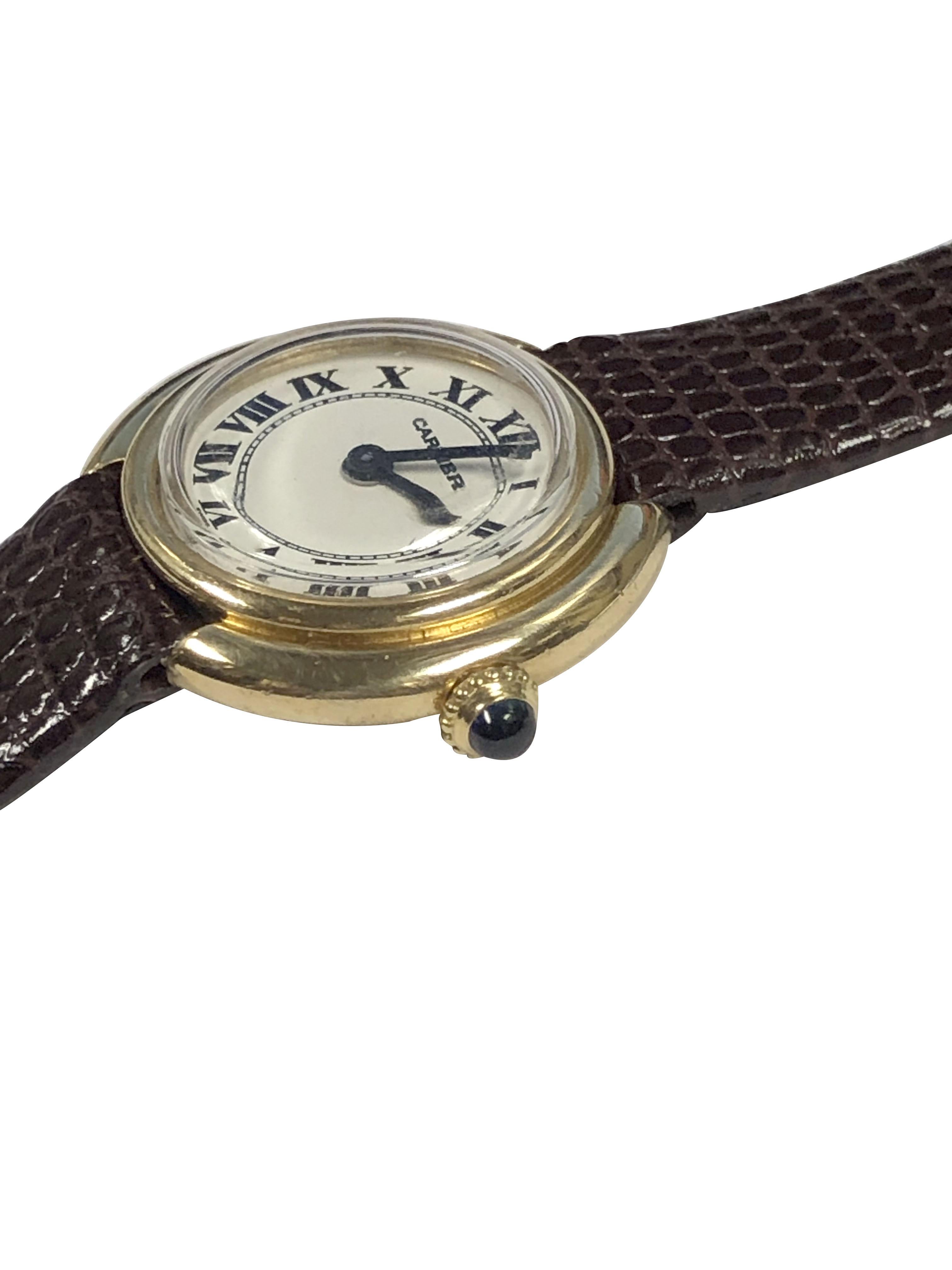 Circa 1970s Cartier Paris Vendome collection Wrist Watch, 22 X 26 M.M. 18k Yellow Gold 2 piece case with stepped Bezel. Mouvement mécanique à remontage manuel, 17 Jewell. Cadran blanc avec chiffres romains noirs, couronne saphir. New Hadley Roma