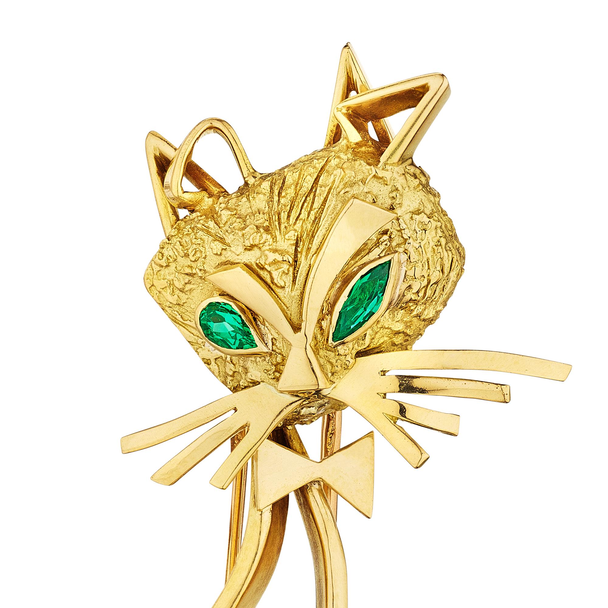 This vintage Cartier Paris 18 karat yellow gold and emerald brooch is the 'cat's meow' and the only one ever made.  With a whimsical spirit, bow tie, and over sized whiskers, this openwork cat brooch will make you smile.  Signed Cartier.  Circa