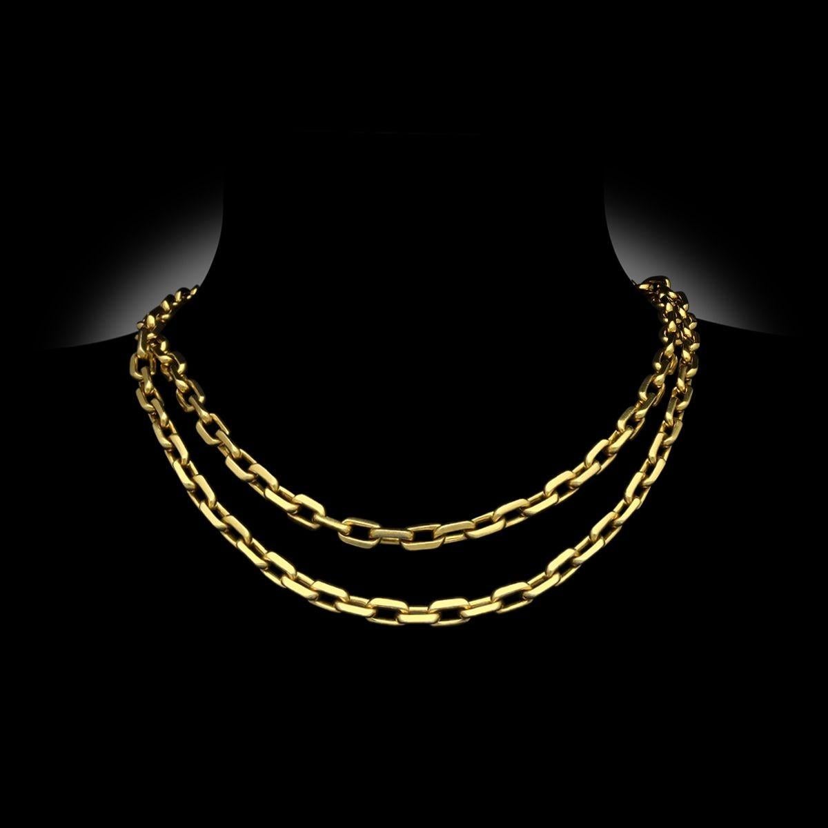 A vintage long gold chain by Cartier Paris, circa 1970. The Santos-Dumont chain is made up of uniform elongated rectangular links in 18ct yellow gold measuring 91cm in length. The necklace connects with a tongue and box clasp fastening and safety