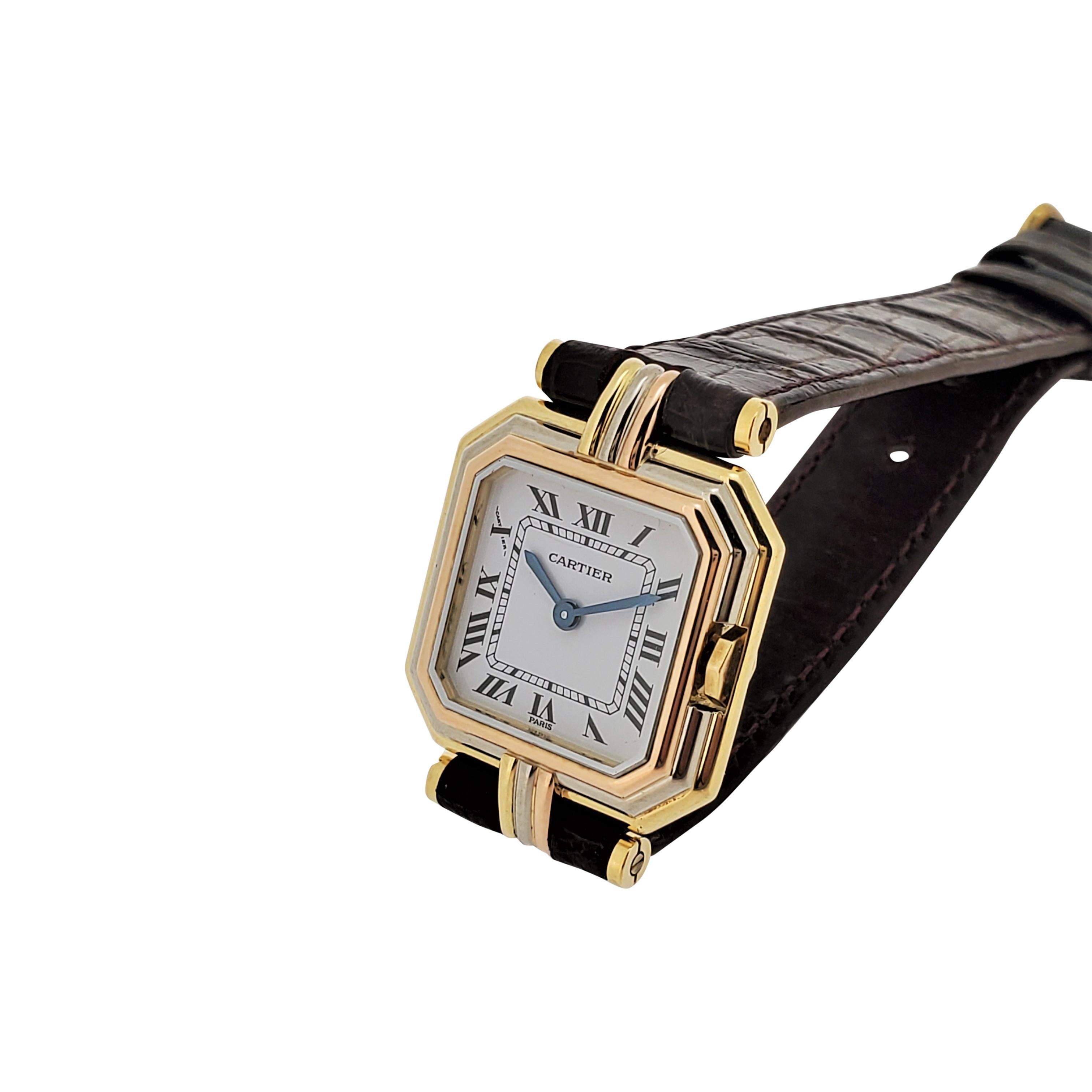Cartier Paris Vintage small Ceinture Tri-Color gold case made in 18K gold measurieng 22 x 29mm lug to lug.  The watch is accompanied with  crocodile strap and buckle.  The watch is in new unpolished condition.  Triple signed,  dial case and
