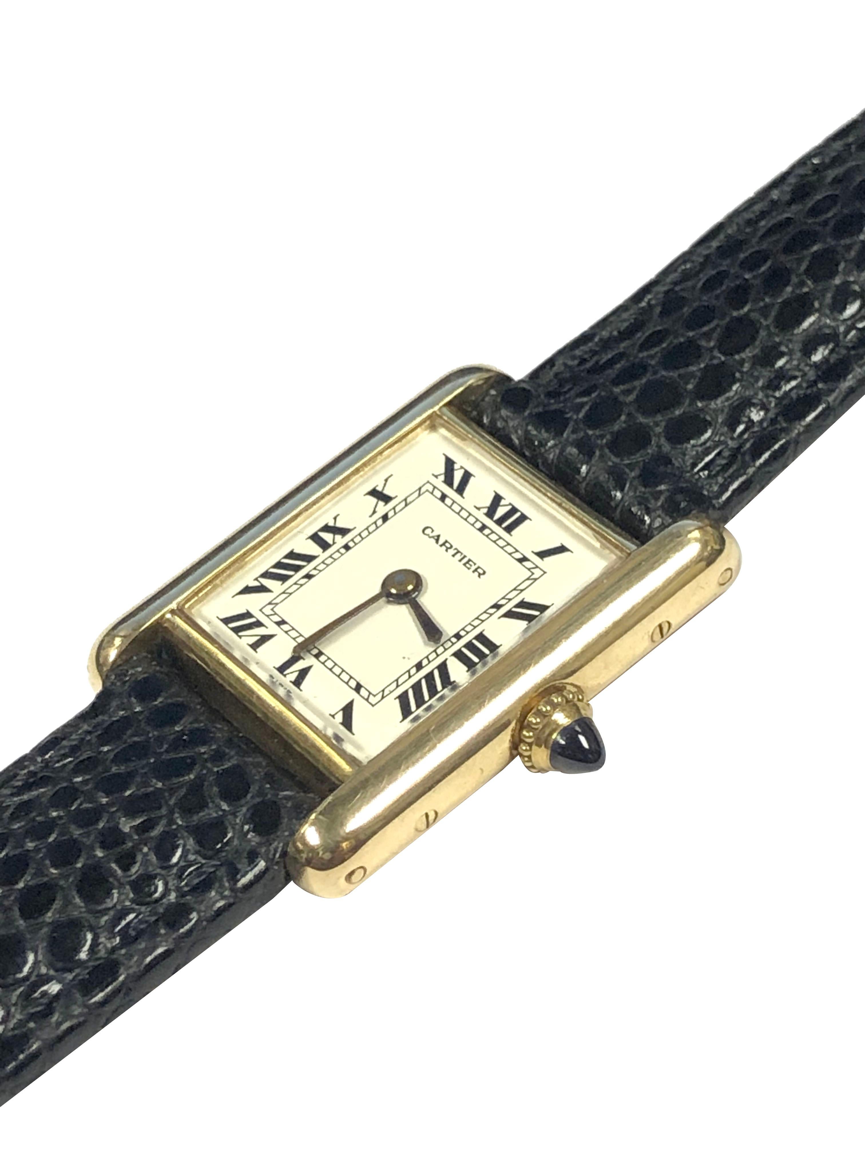 Circa 1970 Cartier Paris Classic Ladies Tank Wrist Watch, 19 X 21 M.M. 18k Yellow Gold 2 piece case. 17 Jewel, Cartier Inc. mechanical, manual wind movement. White Enamel dial with Black Roman numerals, sapphire crown. New Black Lizard Grained